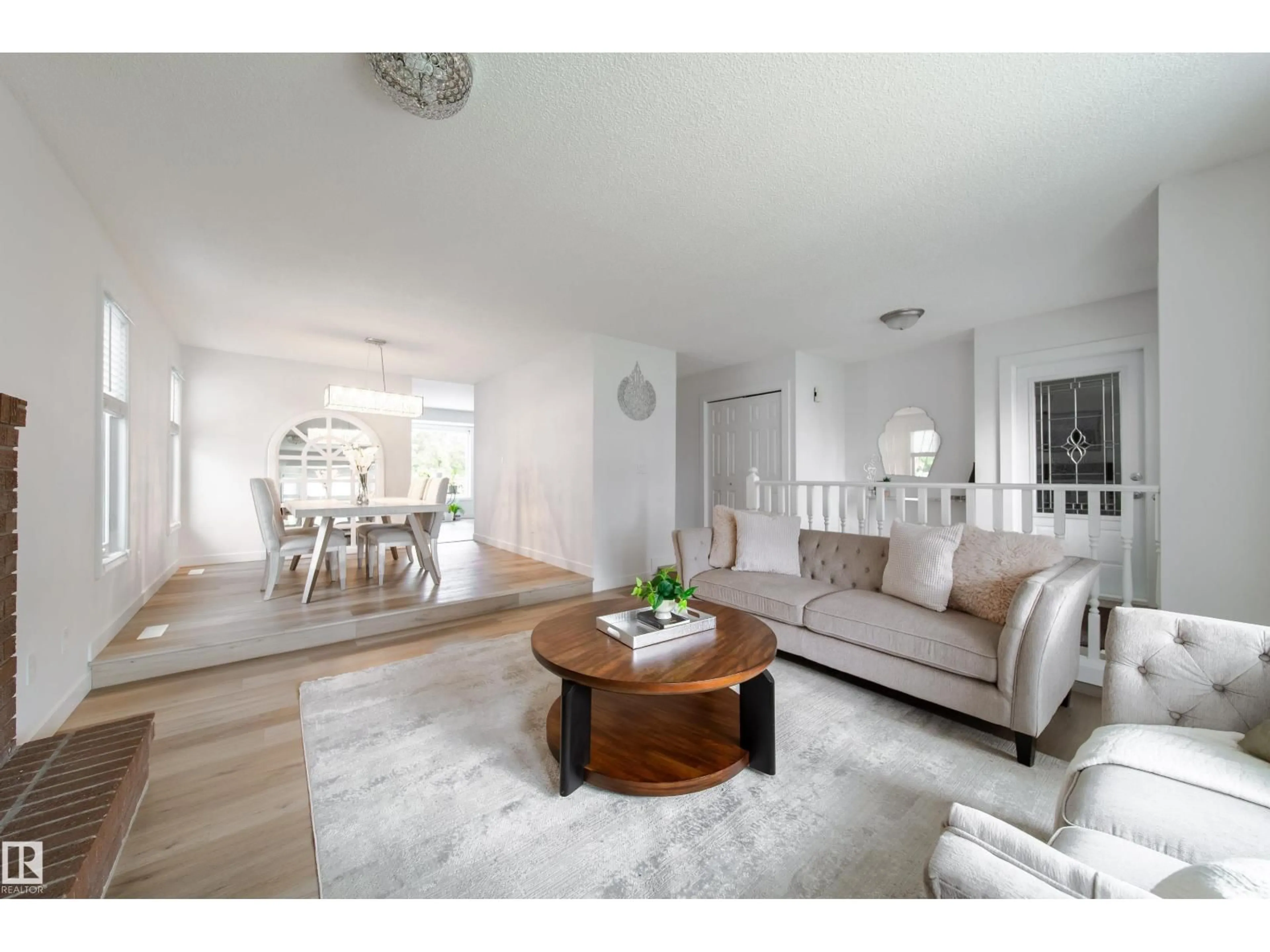 Living room with furniture, wood/laminate floor for NW - 5607 188A ST, Edmonton Alberta T6M2G7