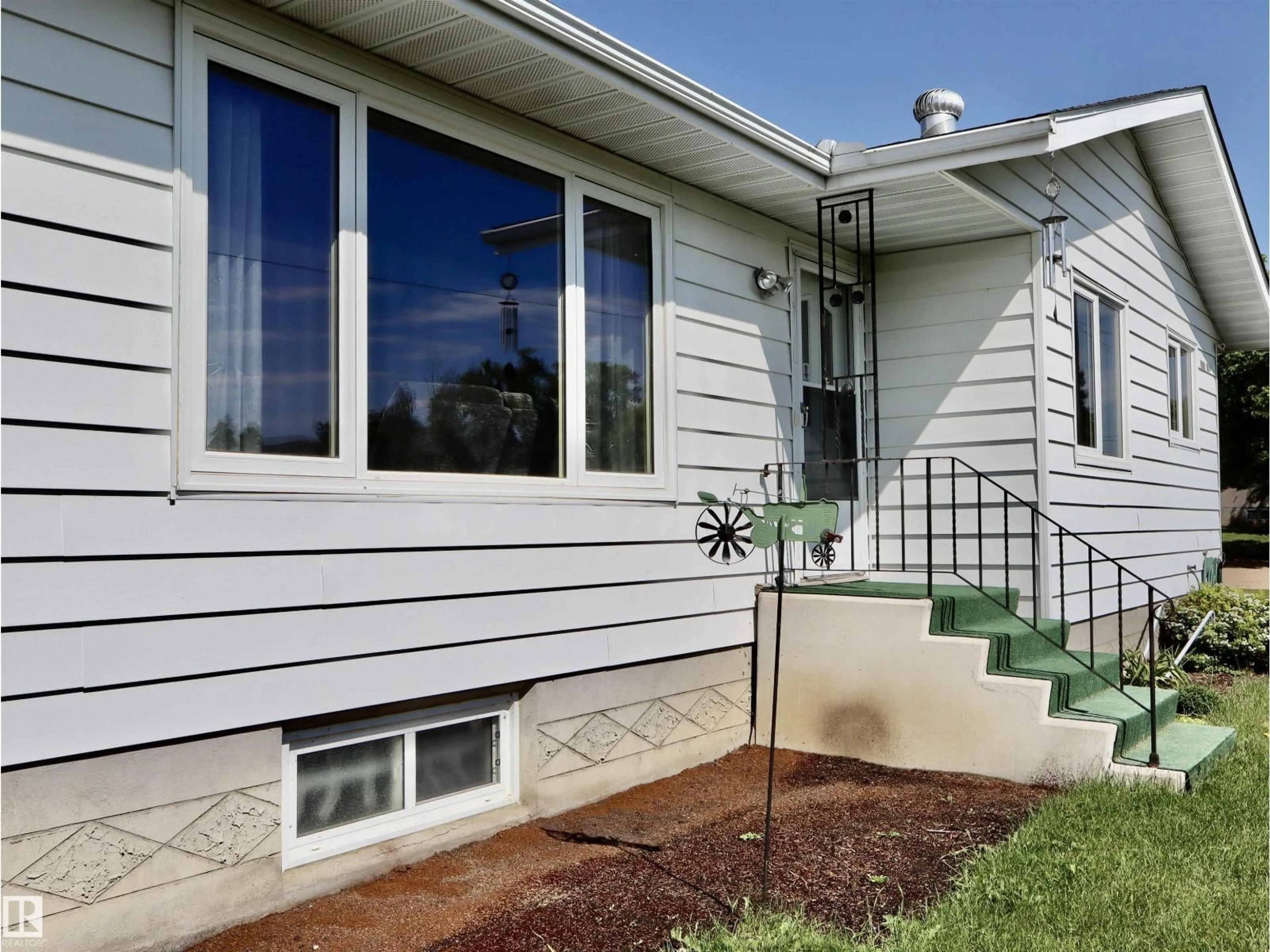 Home with vinyl exterior material, street for 5530 46 STREET, Barrhead Alberta T7N1K6