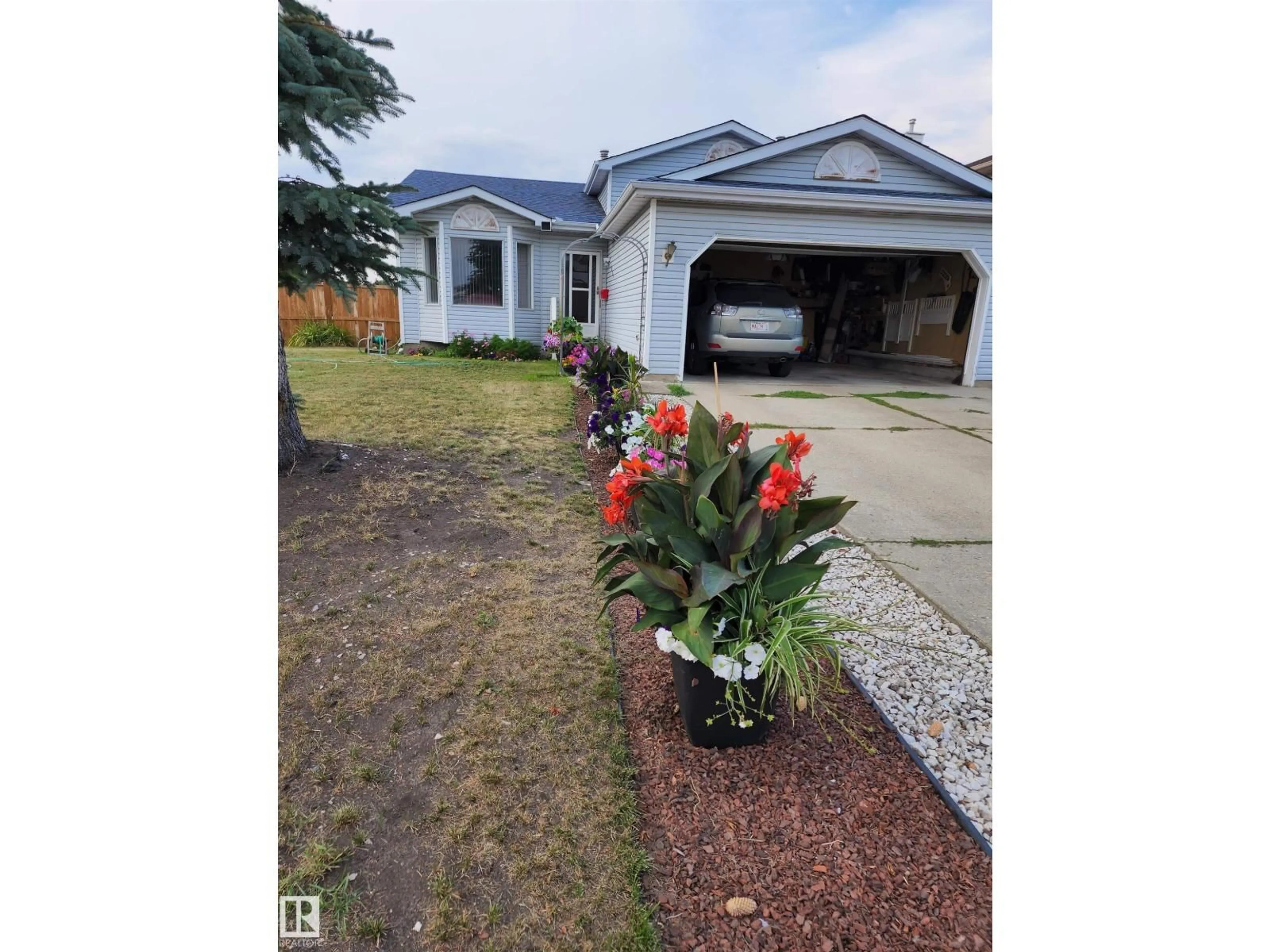 Home with vinyl exterior material, street for 4428 11A AV NW, Edmonton Alberta T6L6M4