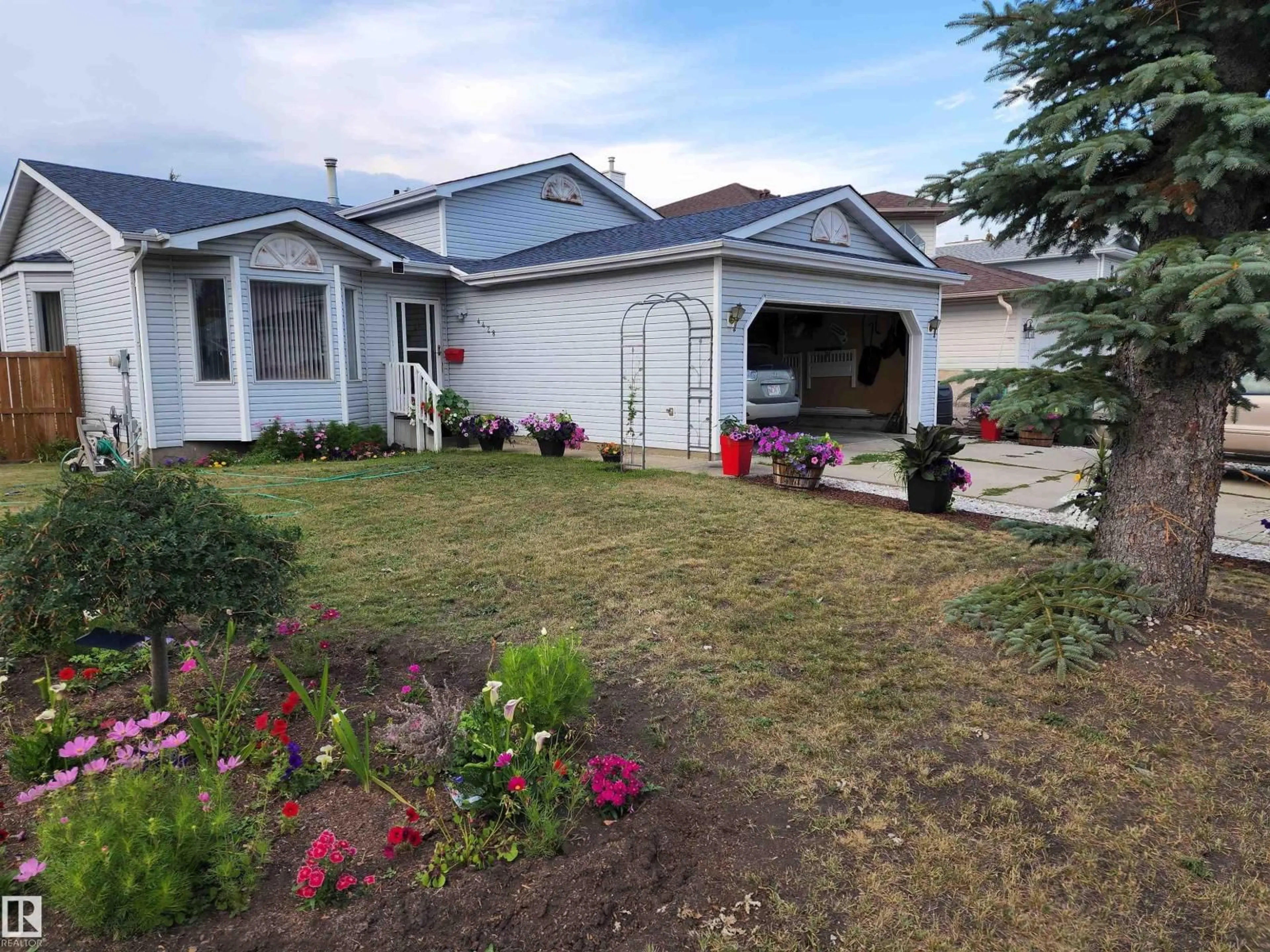 Home with vinyl exterior material, street for 4428 11A AV NW, Edmonton Alberta T6L6M4