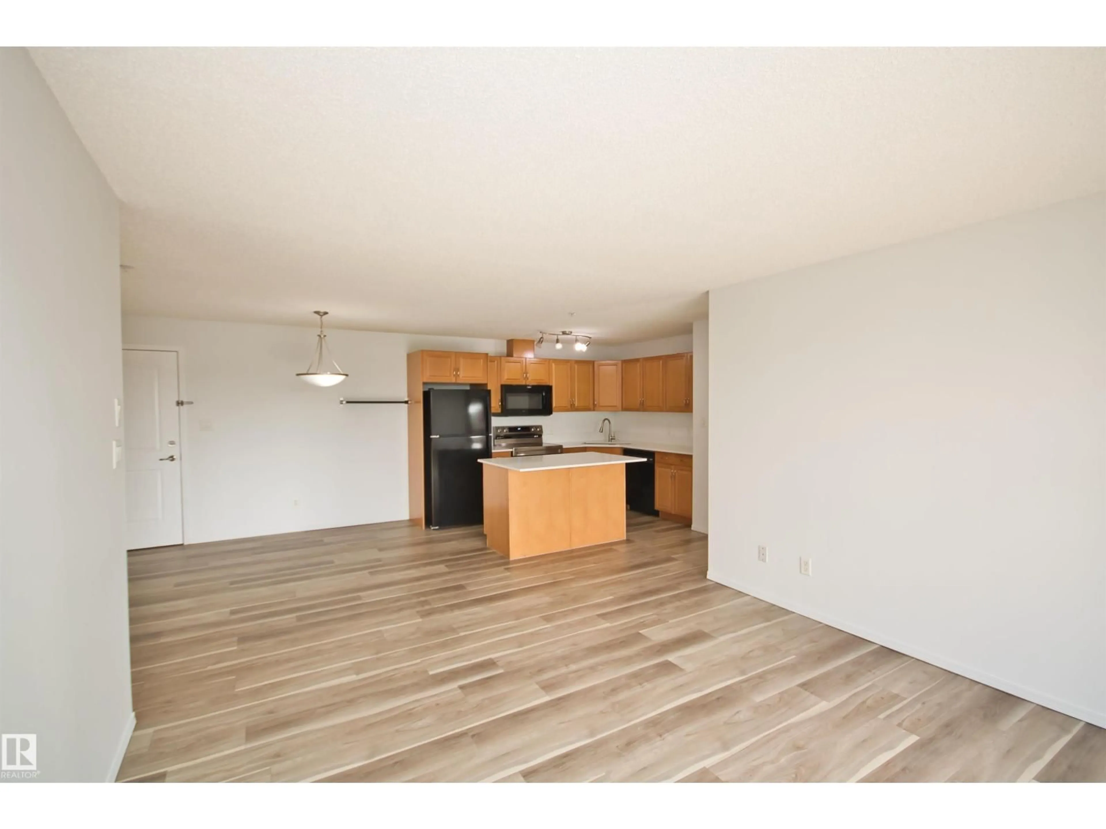 Open concept kitchen, wood/laminate floor for 311 - 2098 BLACKMUD CREEK DR, Edmonton Alberta T6W1T7