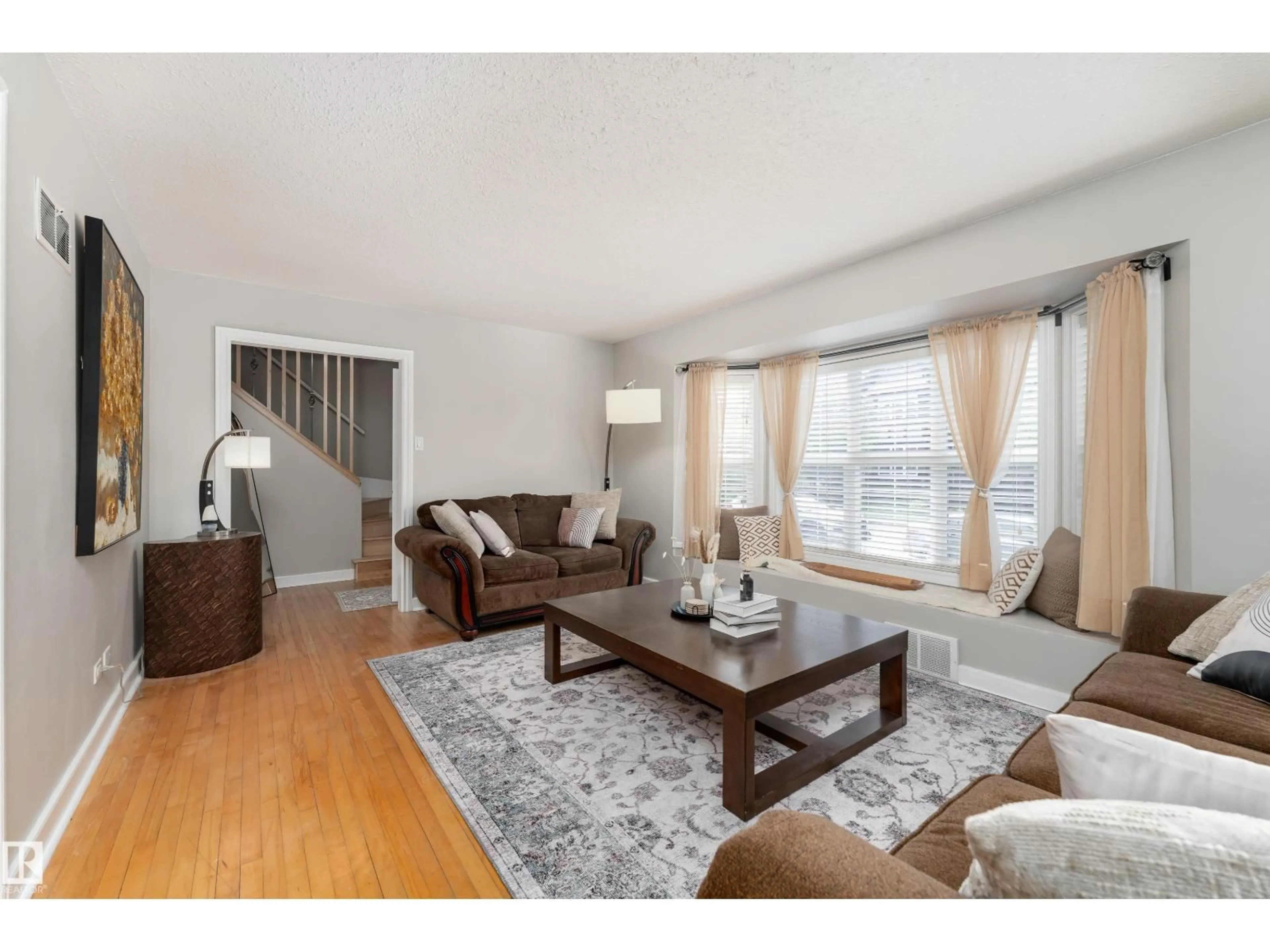 Living room with furniture, wood/laminate floor for 10008 144 AVE, Edmonton Alberta T5E6M5