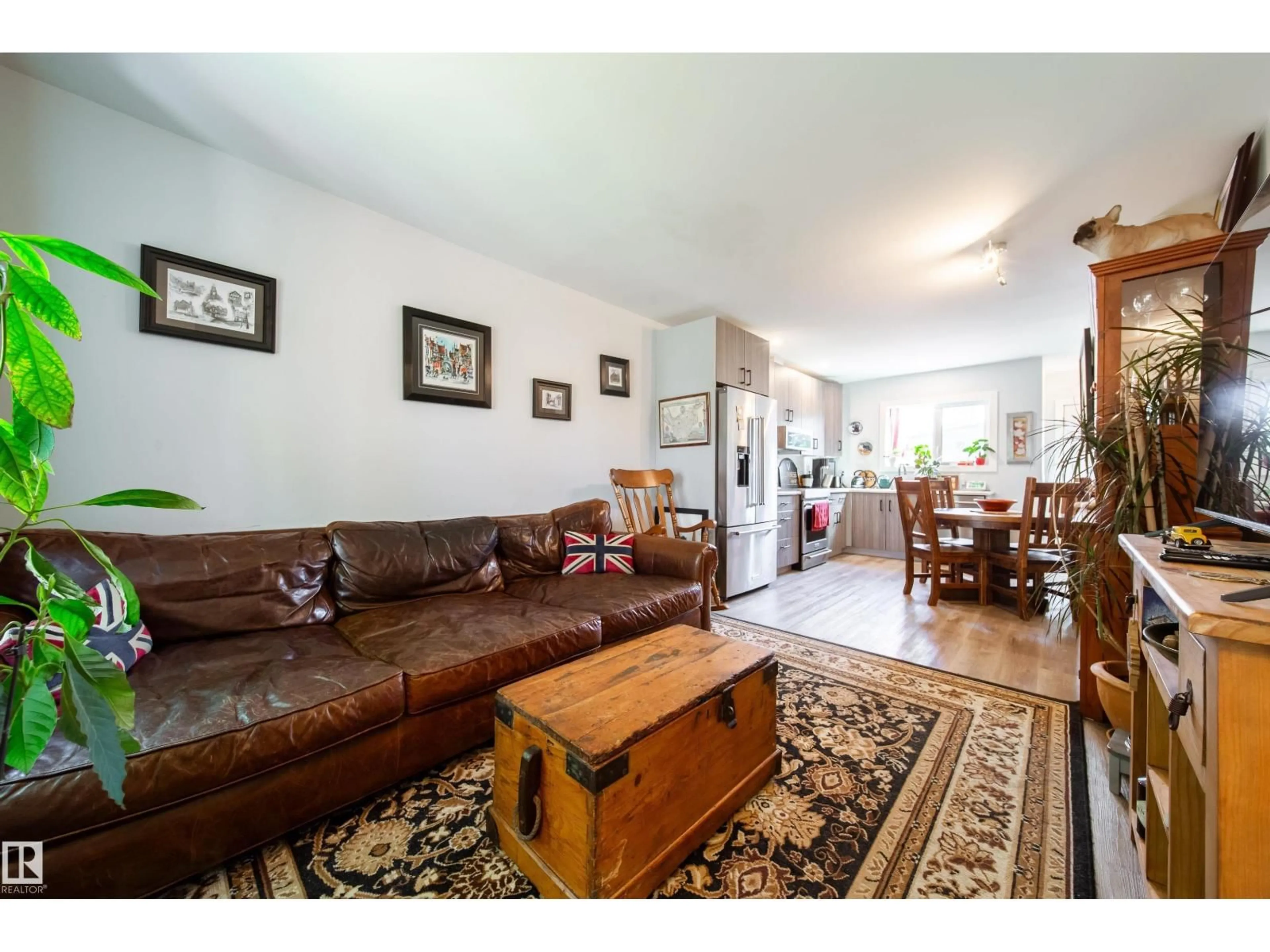 Living room with furniture, wood/laminate floor for 10811 73 AV, Edmonton Alberta T6E1C8