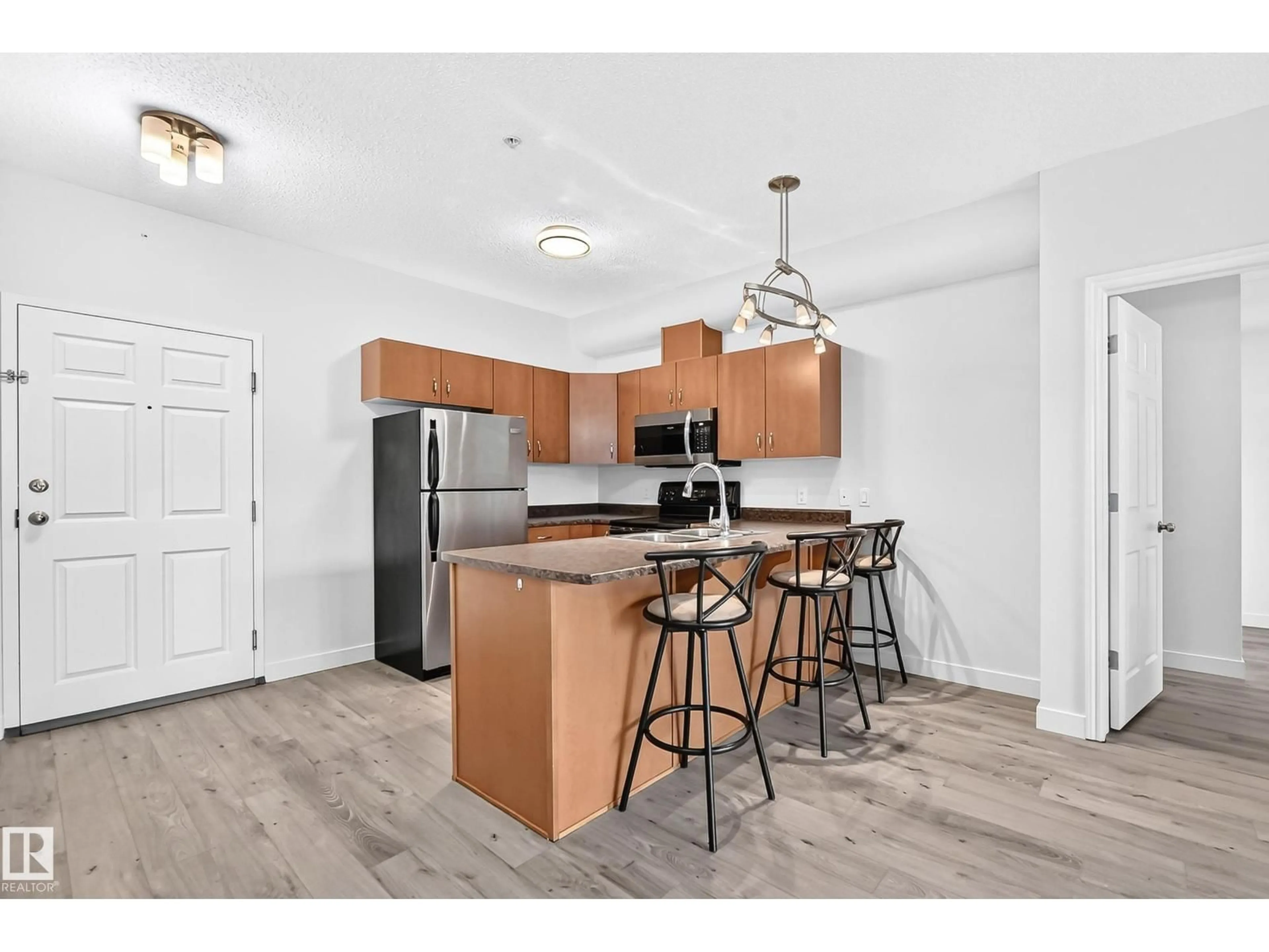 Open concept kitchen, wood/laminate floor for 319 - 10235 112 ST NW, Edmonton Alberta T5K1M7