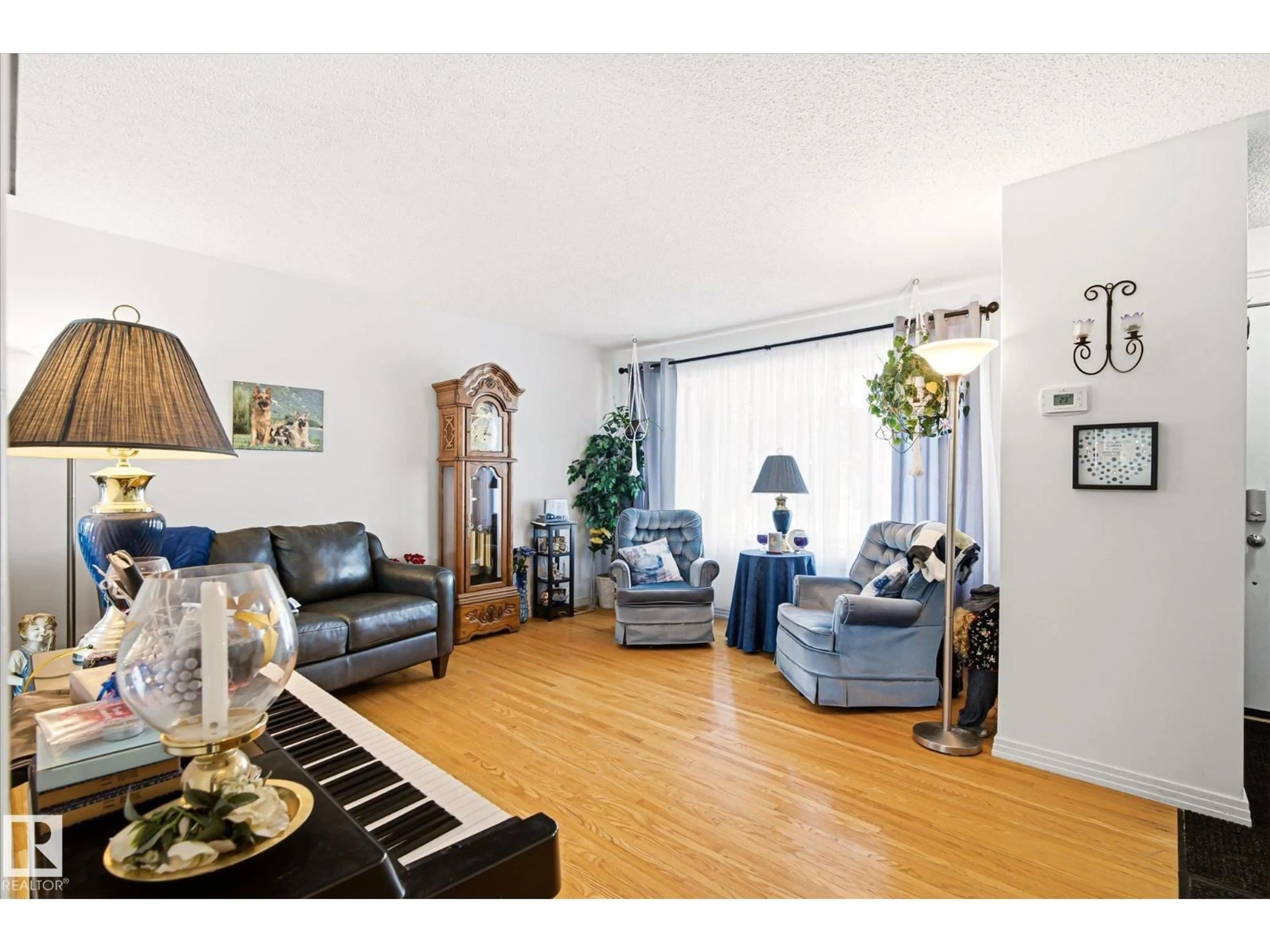 Living room with furniture, wood/laminate floor for NW - 13415 118 AV, Edmonton Alberta T5L2L7