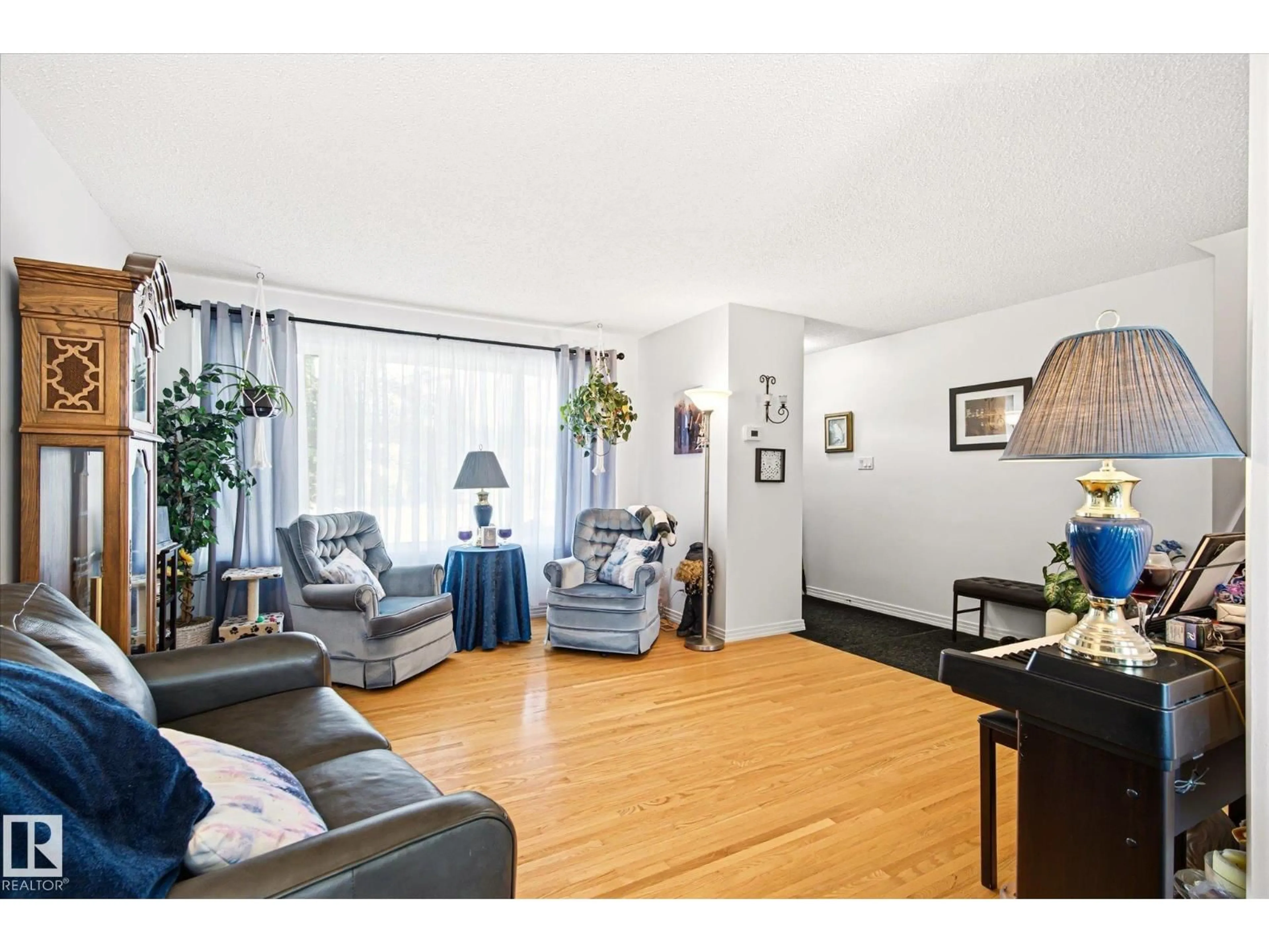 Living room with furniture, wood/laminate floor for NW - 13415 118 AV, Edmonton Alberta T5L2L7
