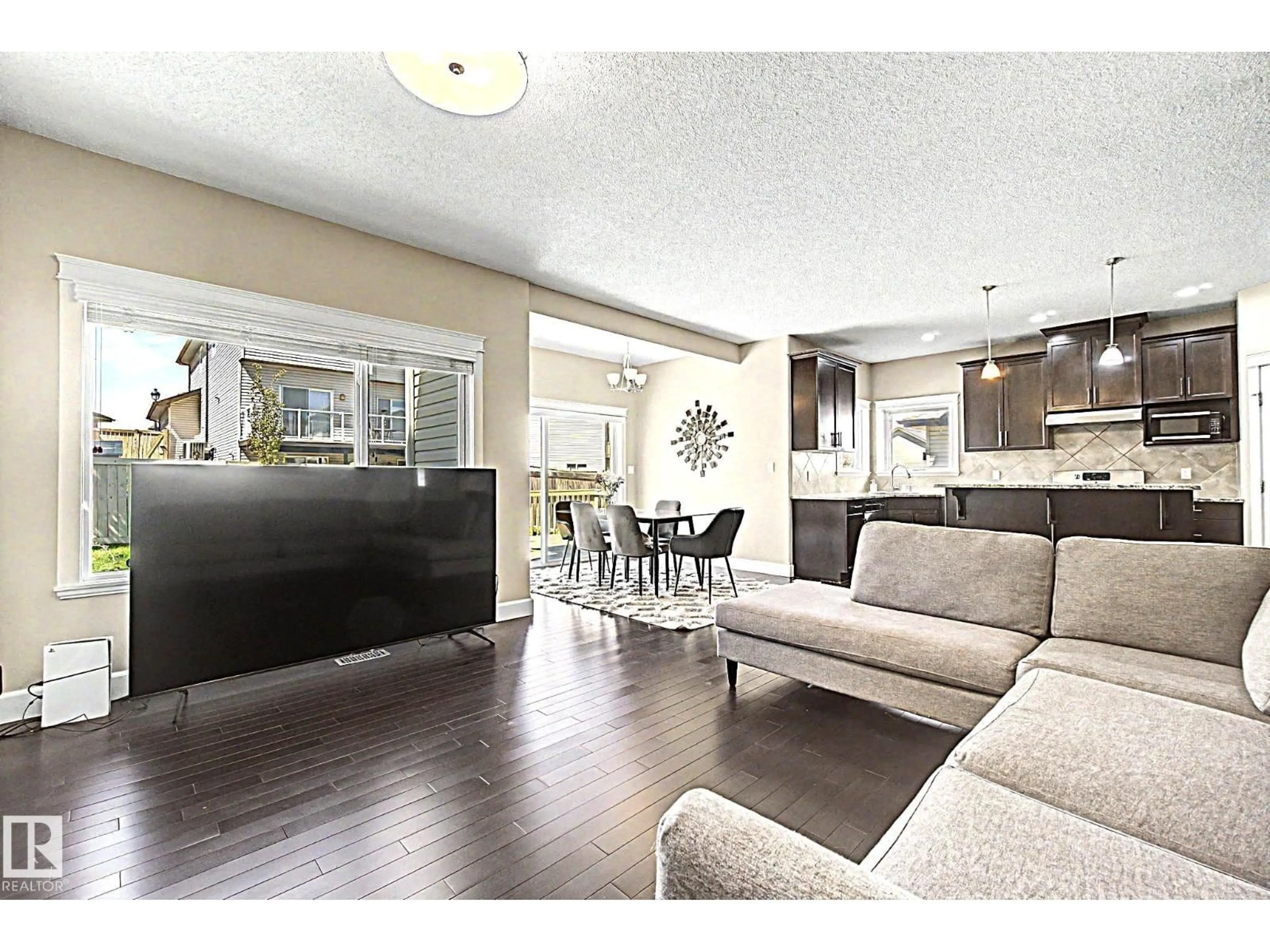 Living room with furniture, wood/laminate floor for SW - 1932 67 ST, Edmonton Alberta T6X0L9
