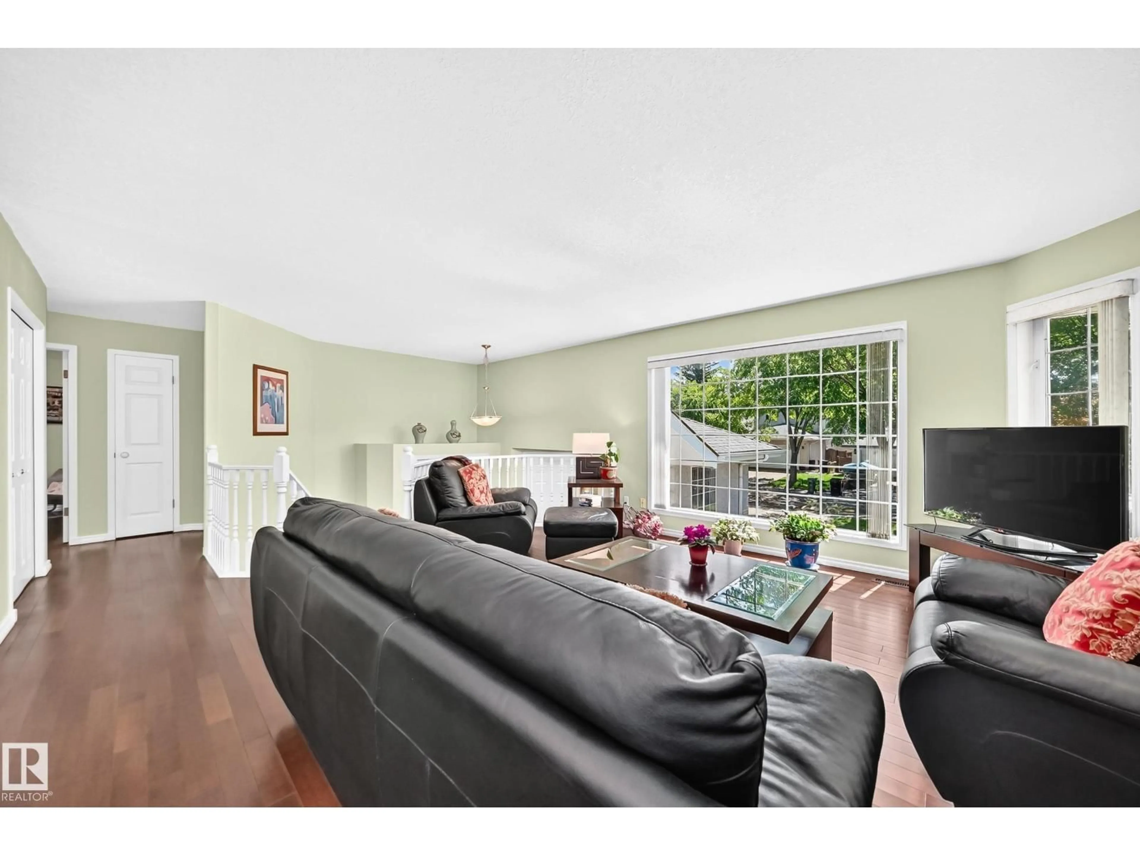 Living room with furniture, wood/laminate floor for 963 BURROWS CR, Edmonton Alberta T6R2L2