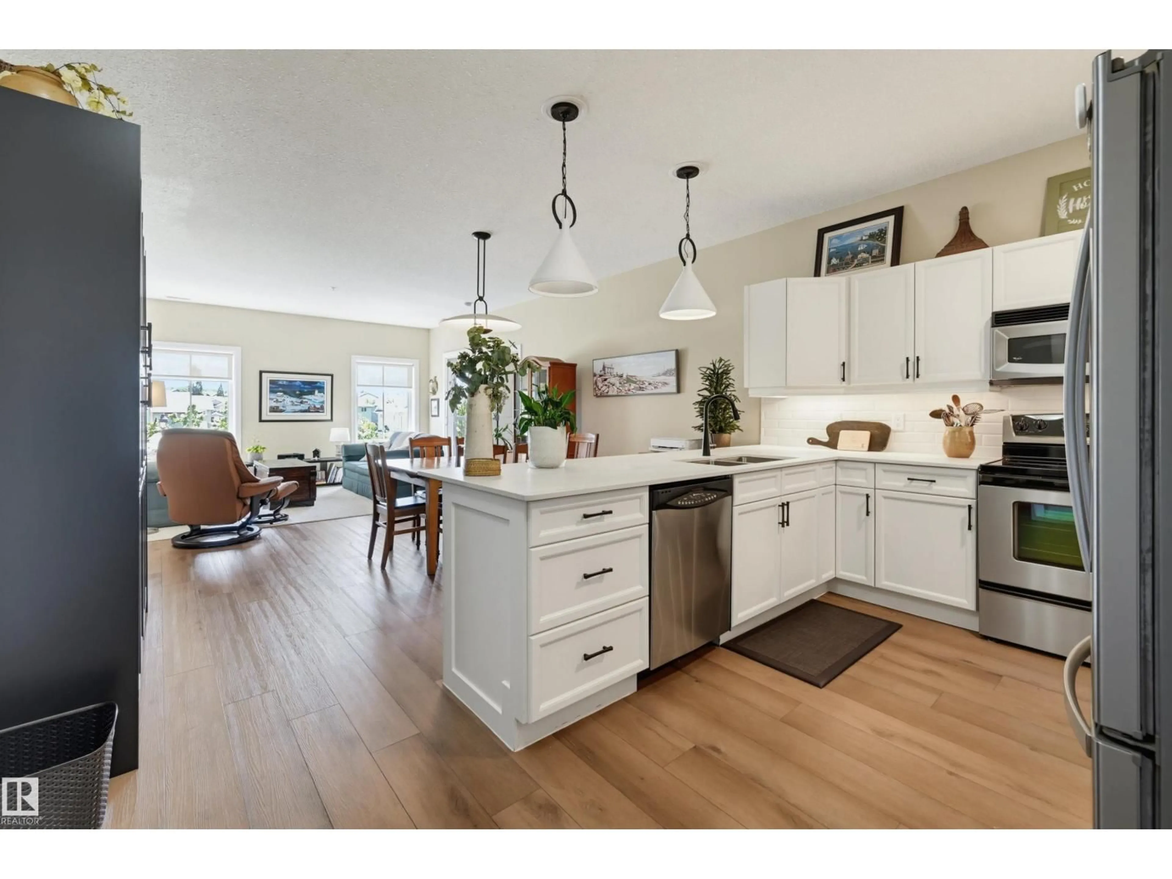 Open concept kitchen, wood/laminate floor for 160 - 328 MAGRATH RD, Edmonton Alberta T6R3T7