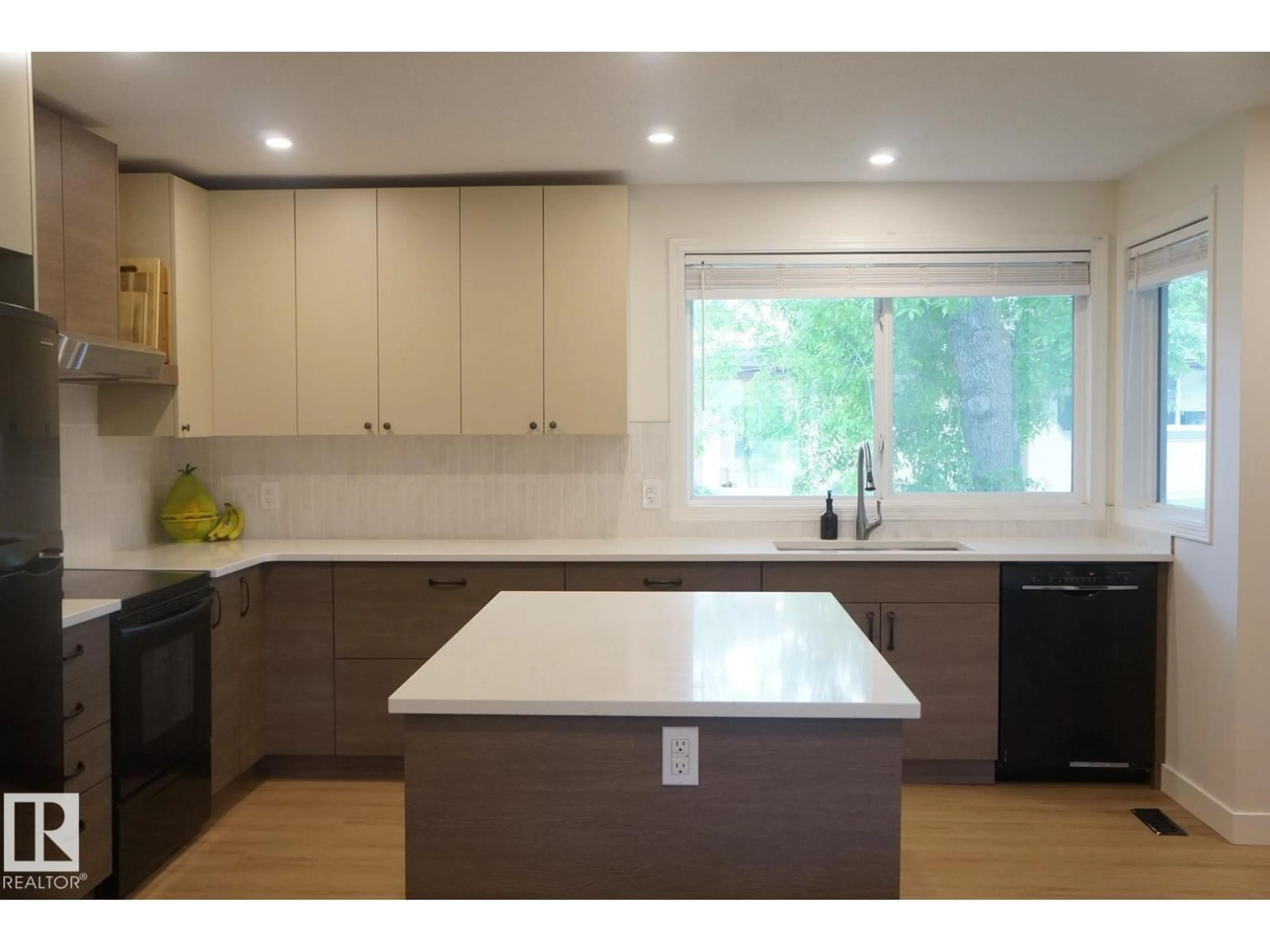 Open concept kitchen, wood/laminate floor for #25 - 8930 99 AV, Fort Saskatchewan Alberta T8L3L1