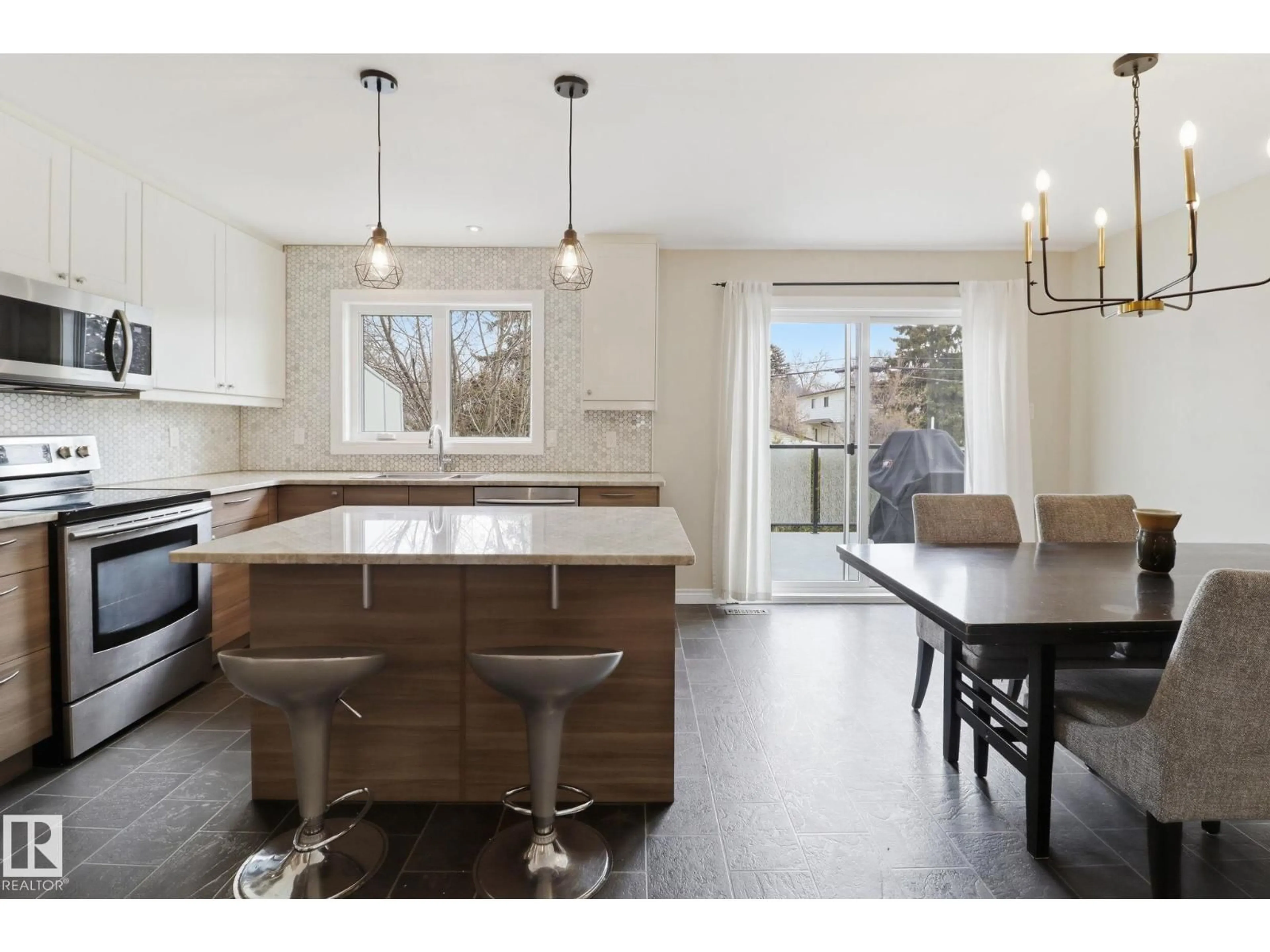 Open concept kitchen, wood/laminate floor for 9023 95 ST, Edmonton Alberta T6C3W7