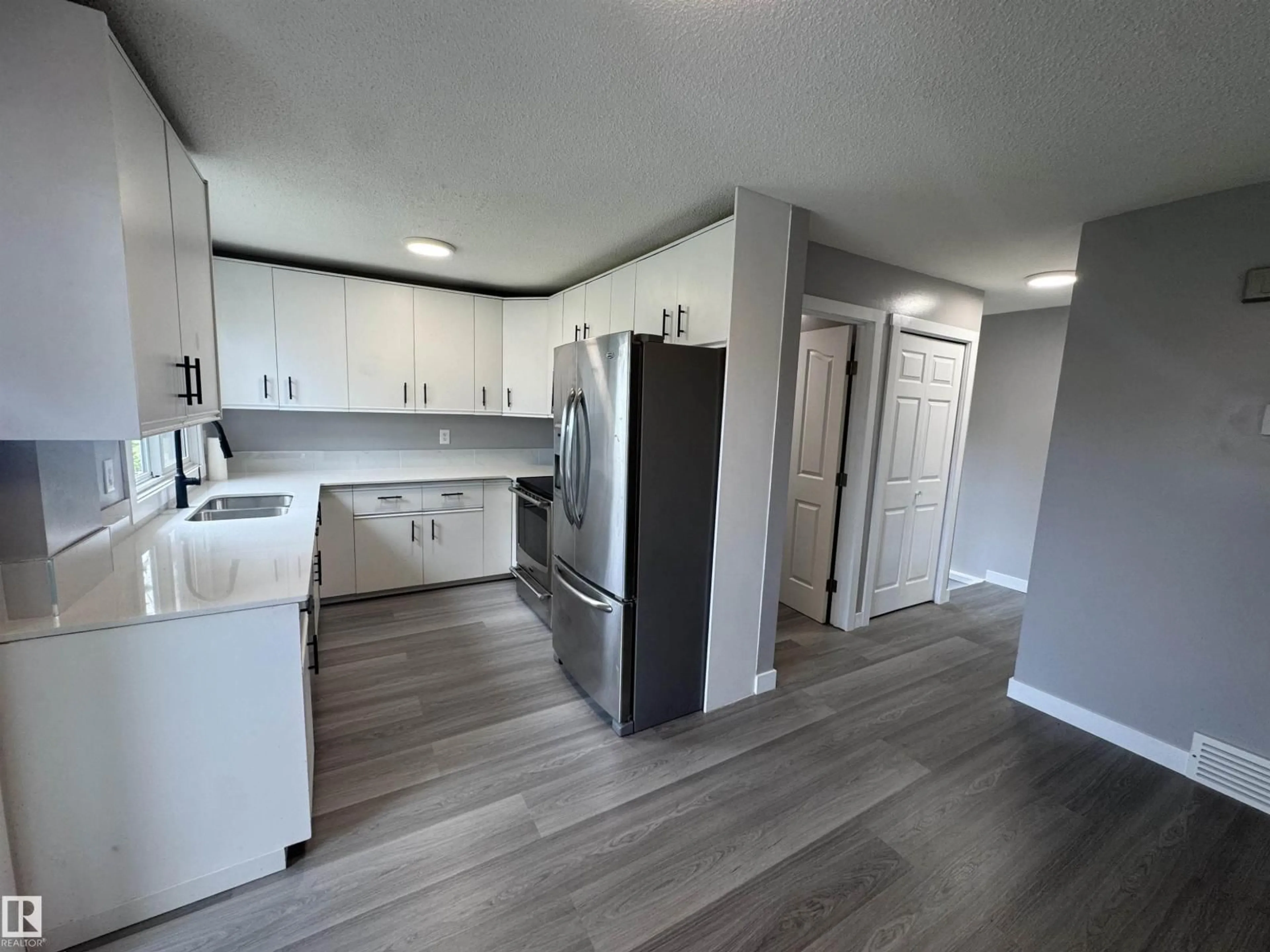 Open concept kitchen, wood/laminate floor for NW - 6441 180 ST, Edmonton Alberta T5T2P3