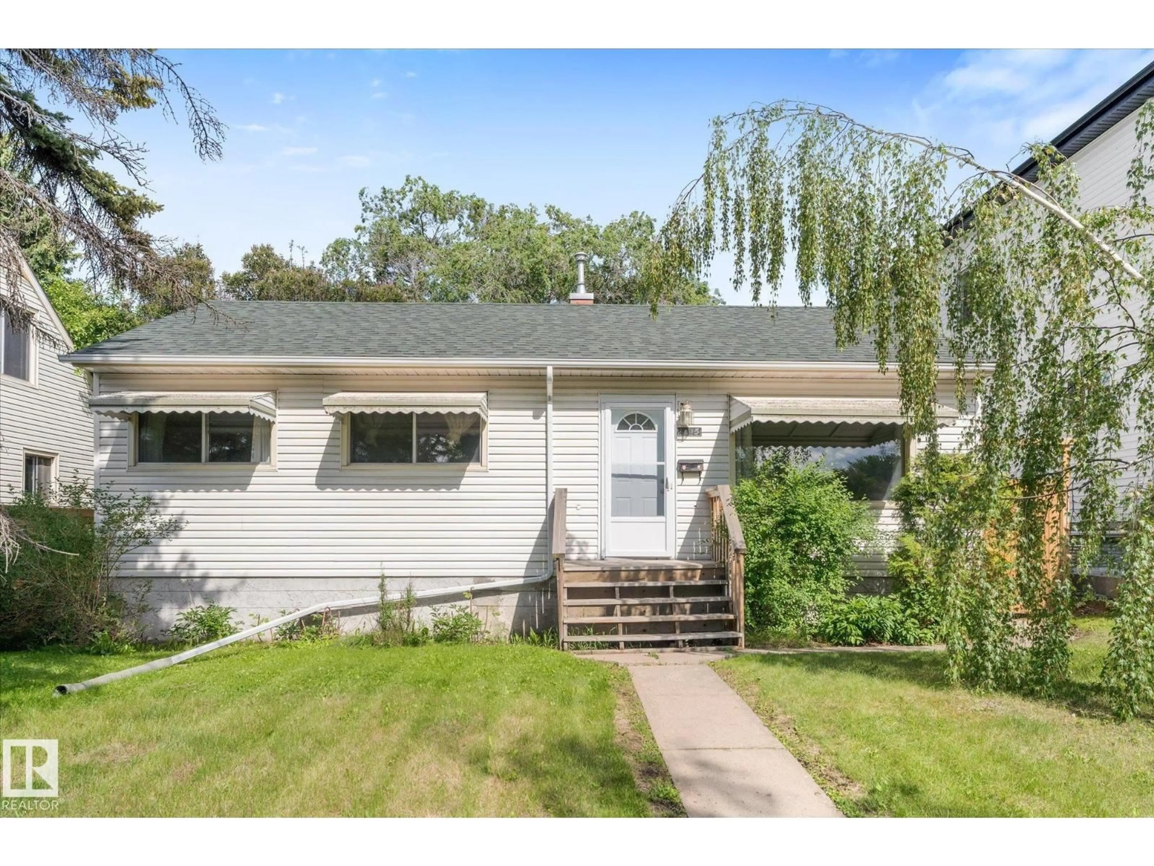 Home with vinyl exterior material, street for 9315 86 ST, Edmonton Alberta T6C3E6