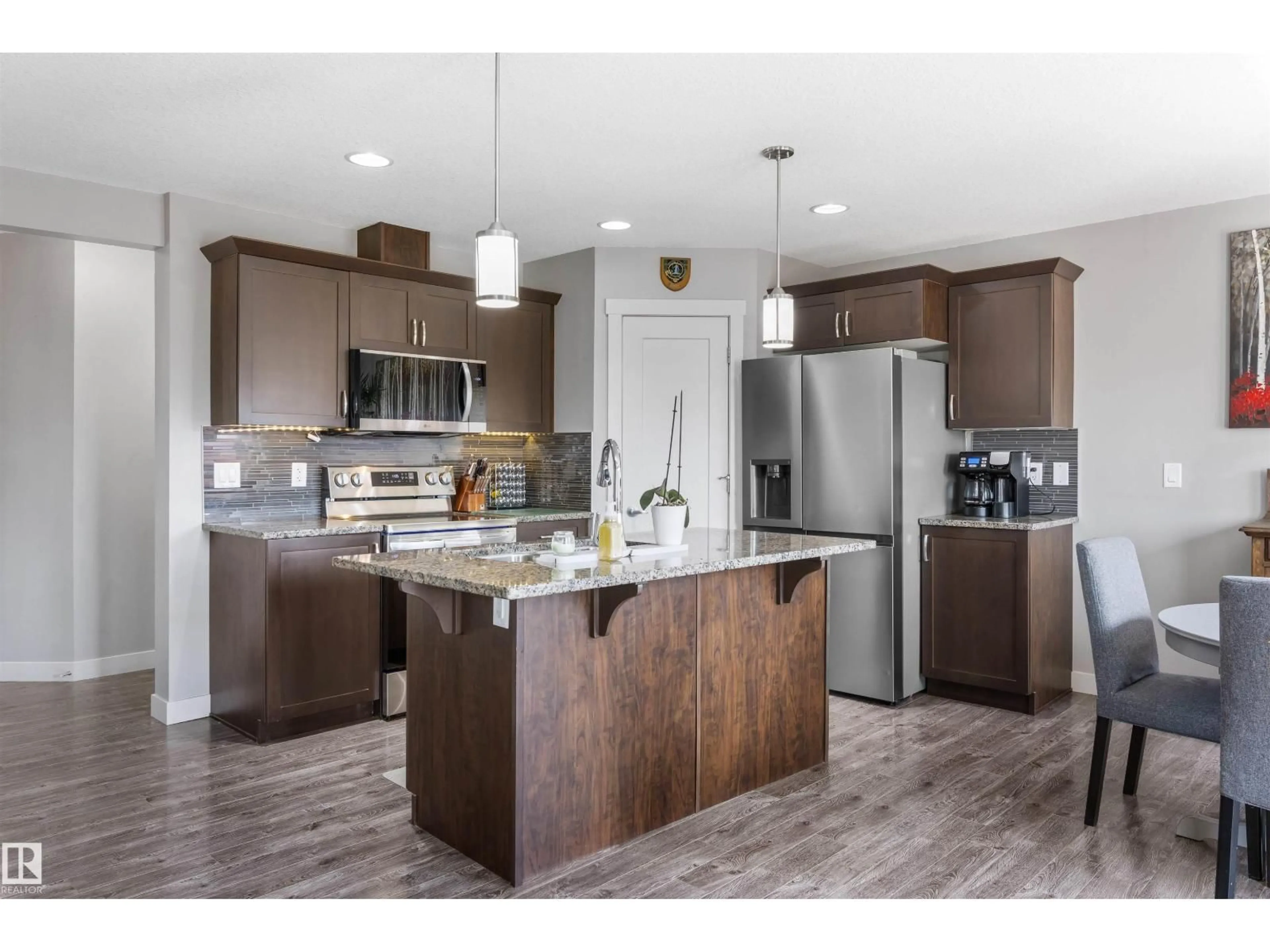 Open concept kitchen, wood/laminate floor for 1651 HAMMOND CR, Edmonton Alberta T6M0L8