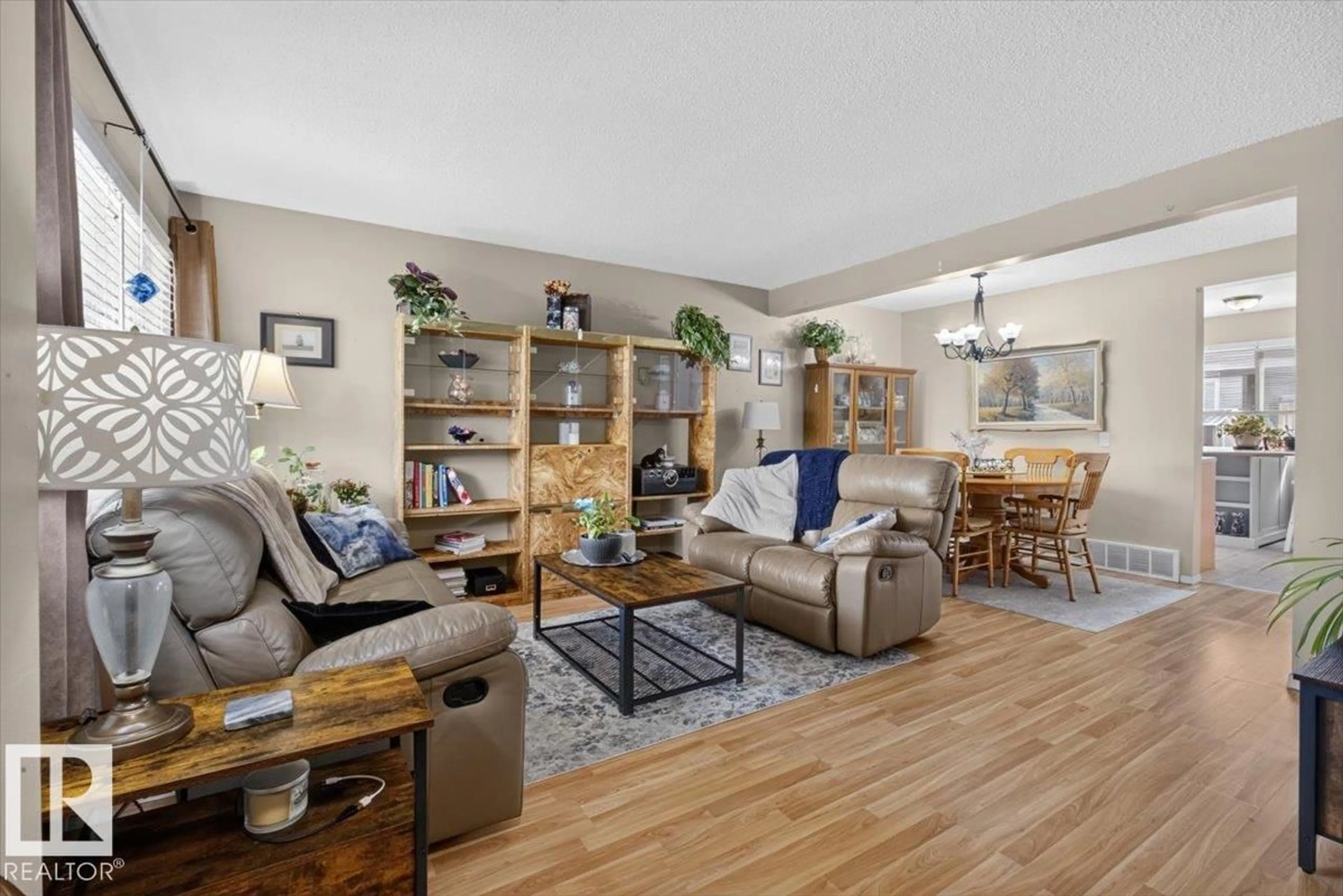 Living room with furniture, wood/laminate floor for 27 WALDEN, St. Albert Alberta T8N3V6