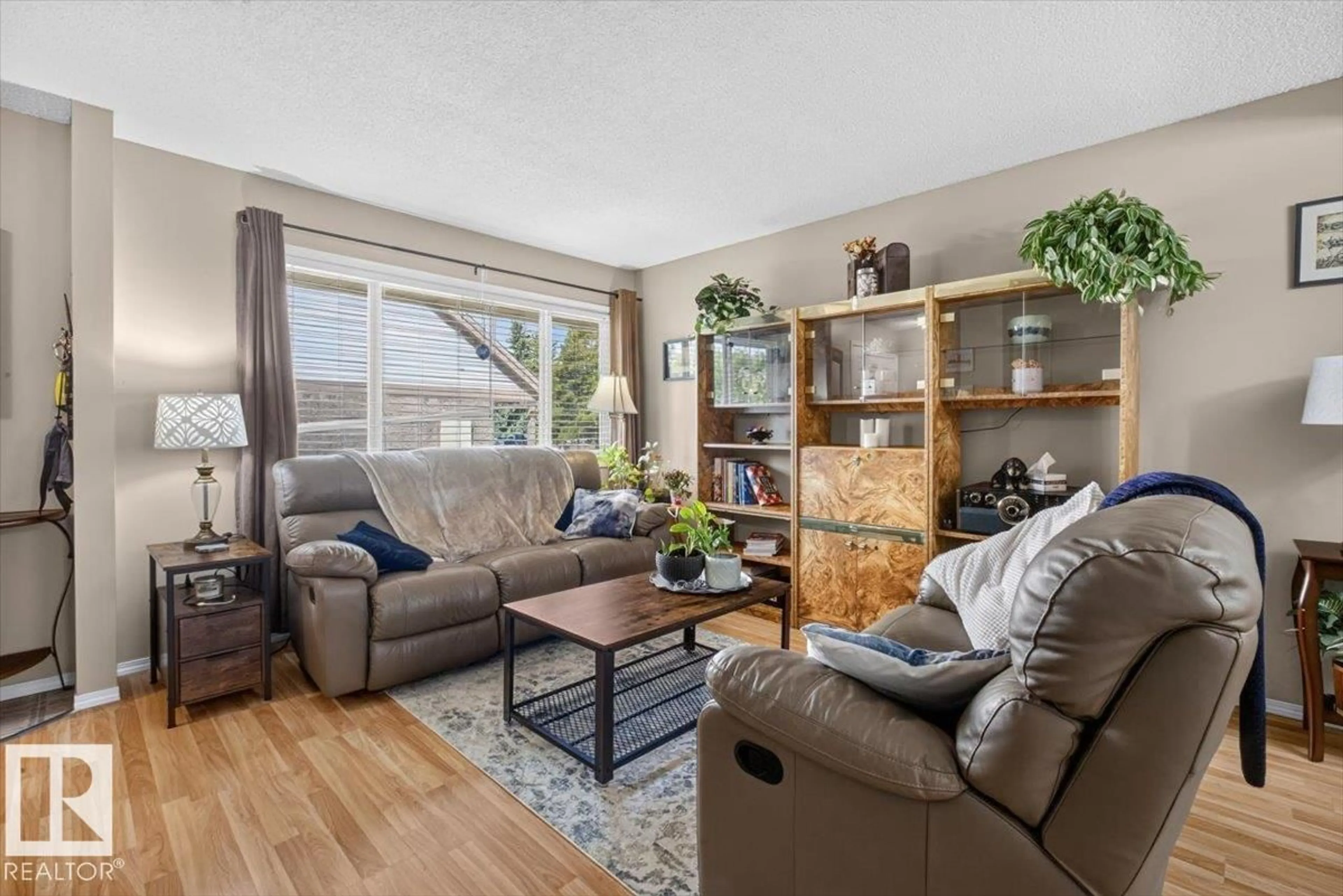 Living room with furniture, wood/laminate floor for 27 WALDEN, St. Albert Alberta T8N3V6