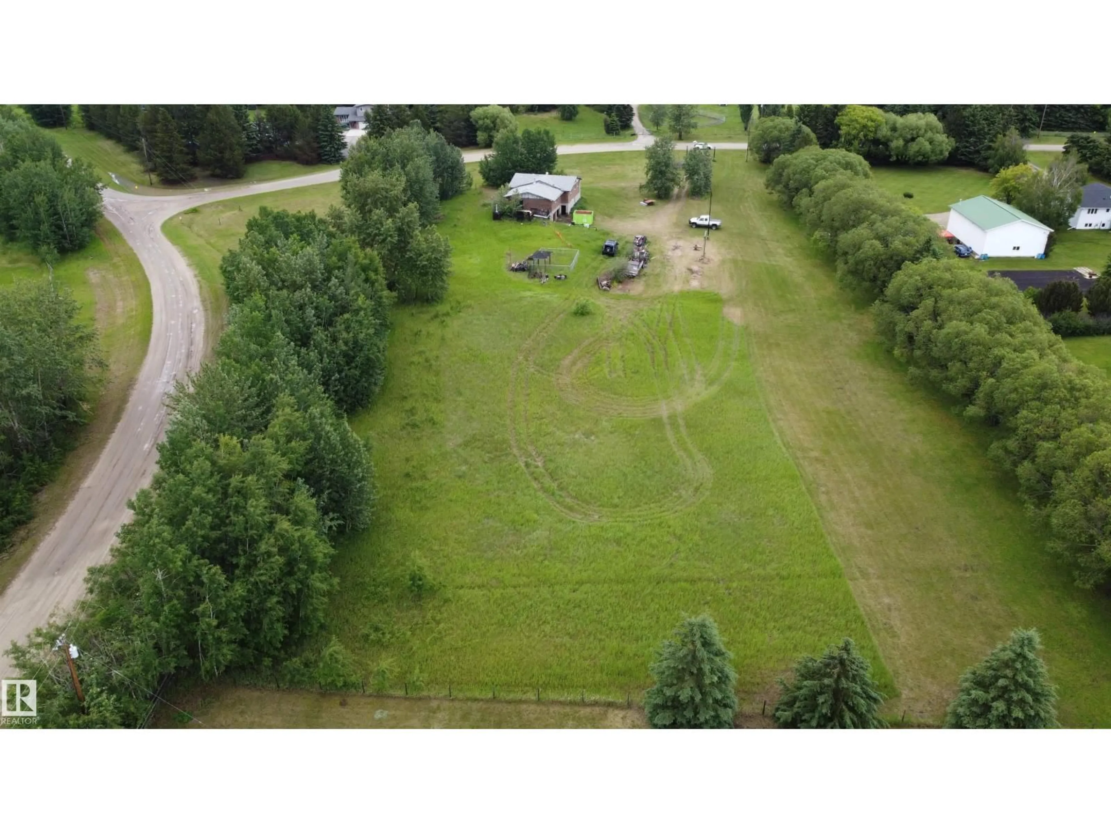 A pic from outside/outdoor area/front of a property/back of a property/a pic from drone, forest/trees view for #4 - 27317 TWP ROAD 522, Rural Parkland County Alberta T7X3S3
