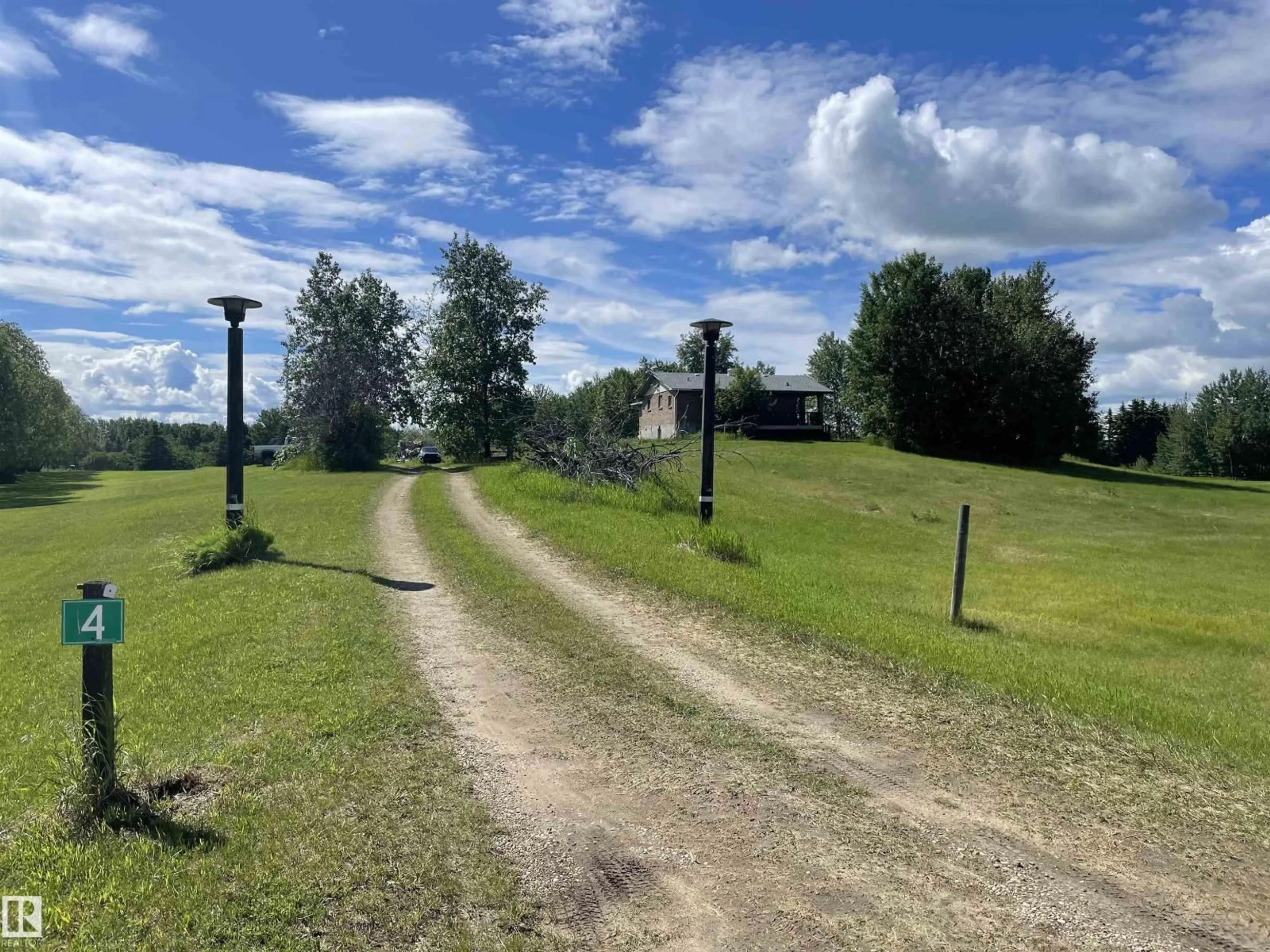 A pic from outside/outdoor area/front of a property/back of a property/a pic from drone, street for #4 - 27317 TWP ROAD 522, Rural Parkland County Alberta T7X3S3