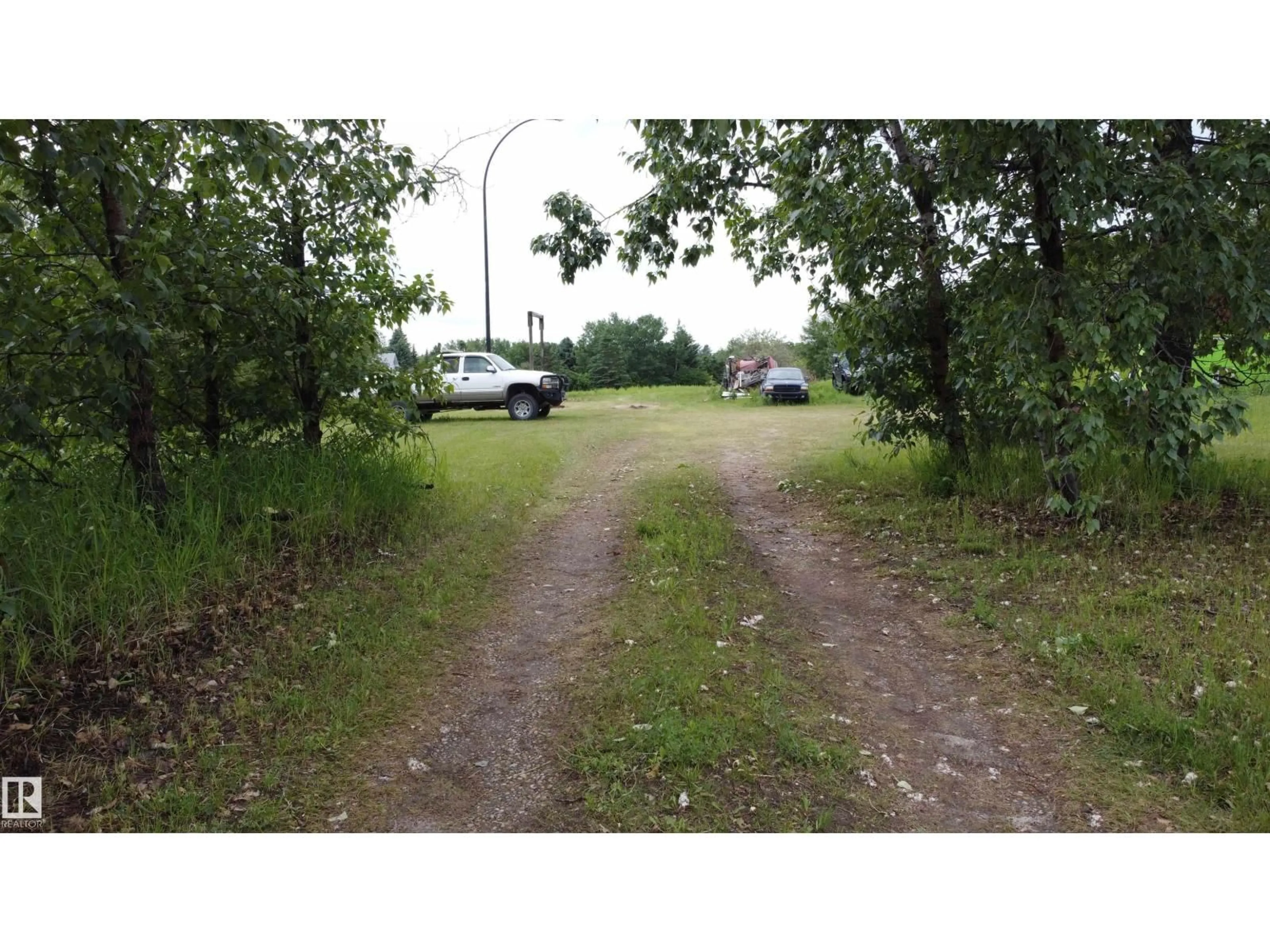 A pic from outside/outdoor area/front of a property/back of a property/a pic from drone, street for #4 - 27317 TWP ROAD 522, Rural Parkland County Alberta T7X3S3