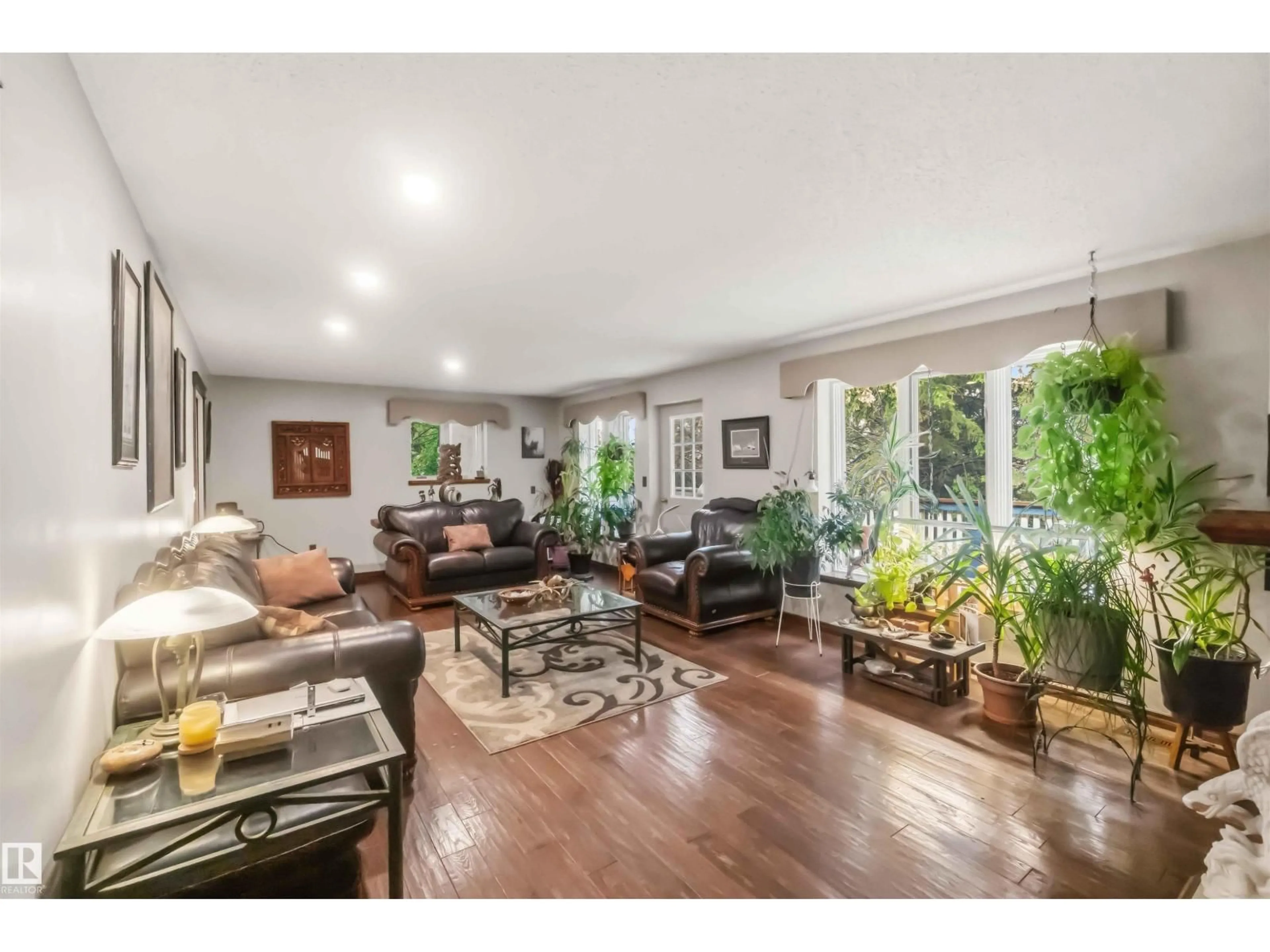 Living room with furniture, wood/laminate floor for 52510 - 28 RGE ROAD 20, Rural Parkland County Alberta T7Y2G7