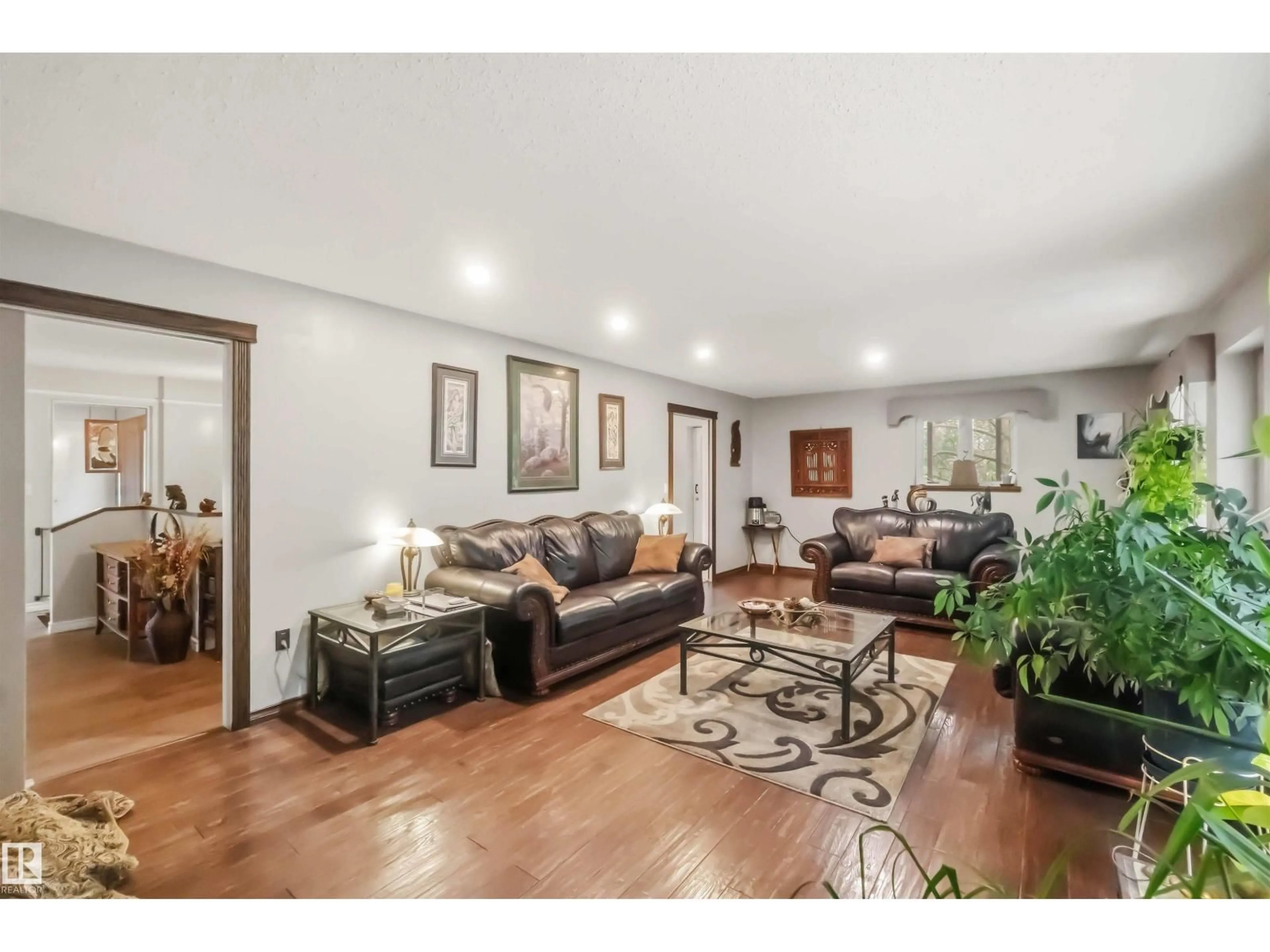 Living room with furniture, wood/laminate floor for 52510 - 28 RGE ROAD 20, Rural Parkland County Alberta T7Y2G7