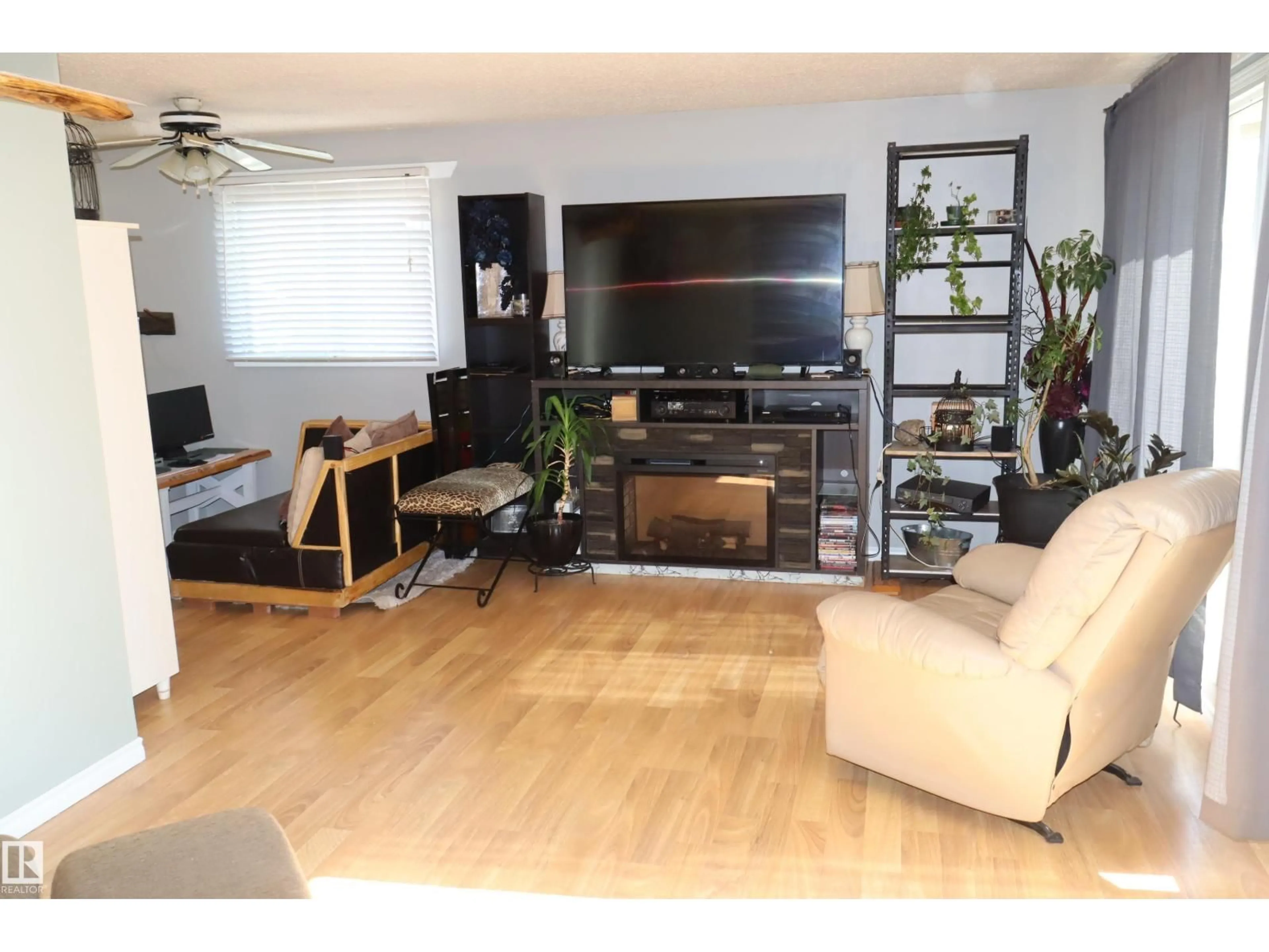 Living room with furniture, wood/laminate floor for 147 GARWOOD CR, Wetaskiwin Alberta T9A2X4