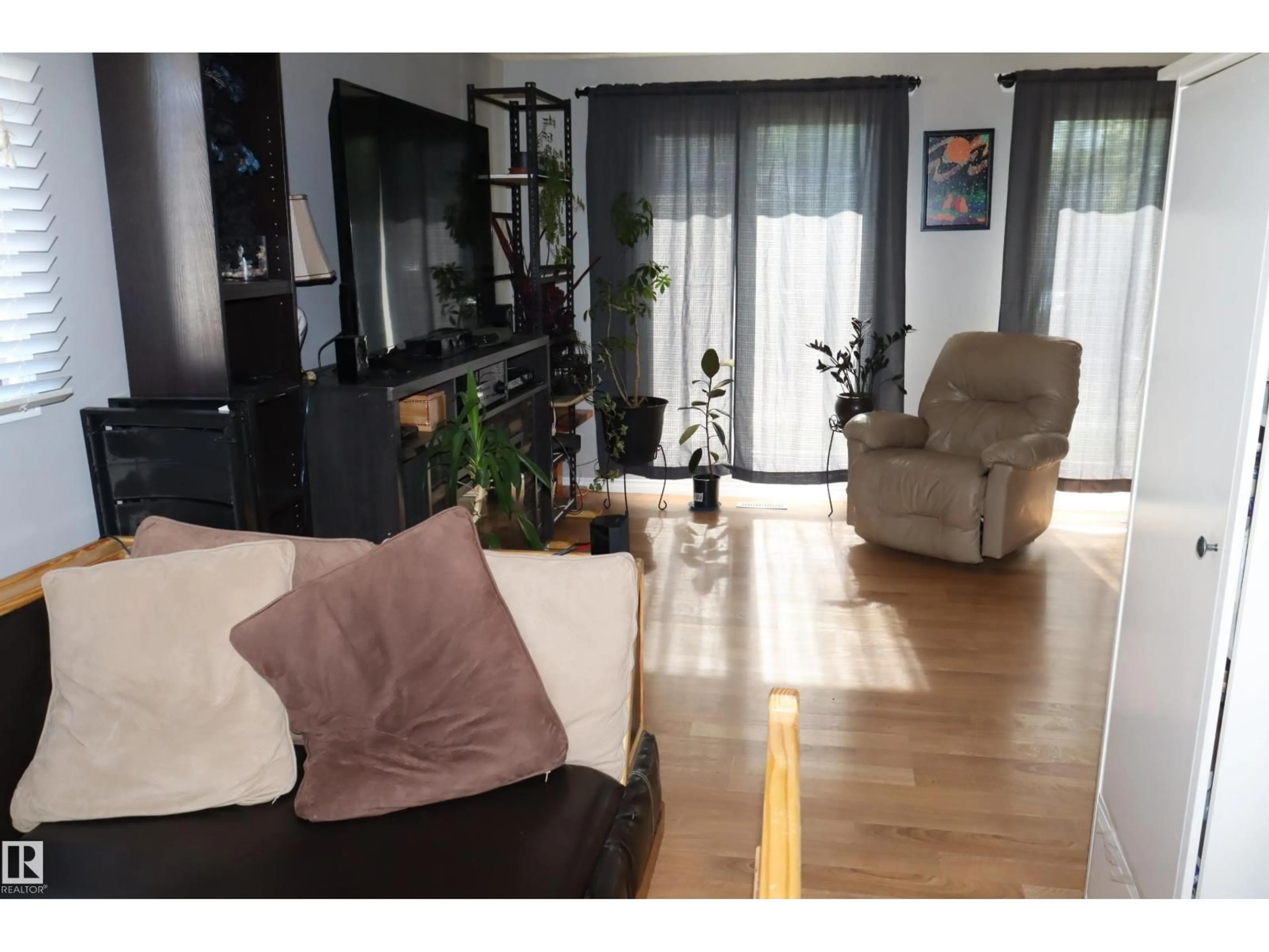 Living room with furniture, wood/laminate floor for 147 GARWOOD CR, Wetaskiwin Alberta T9A2X4