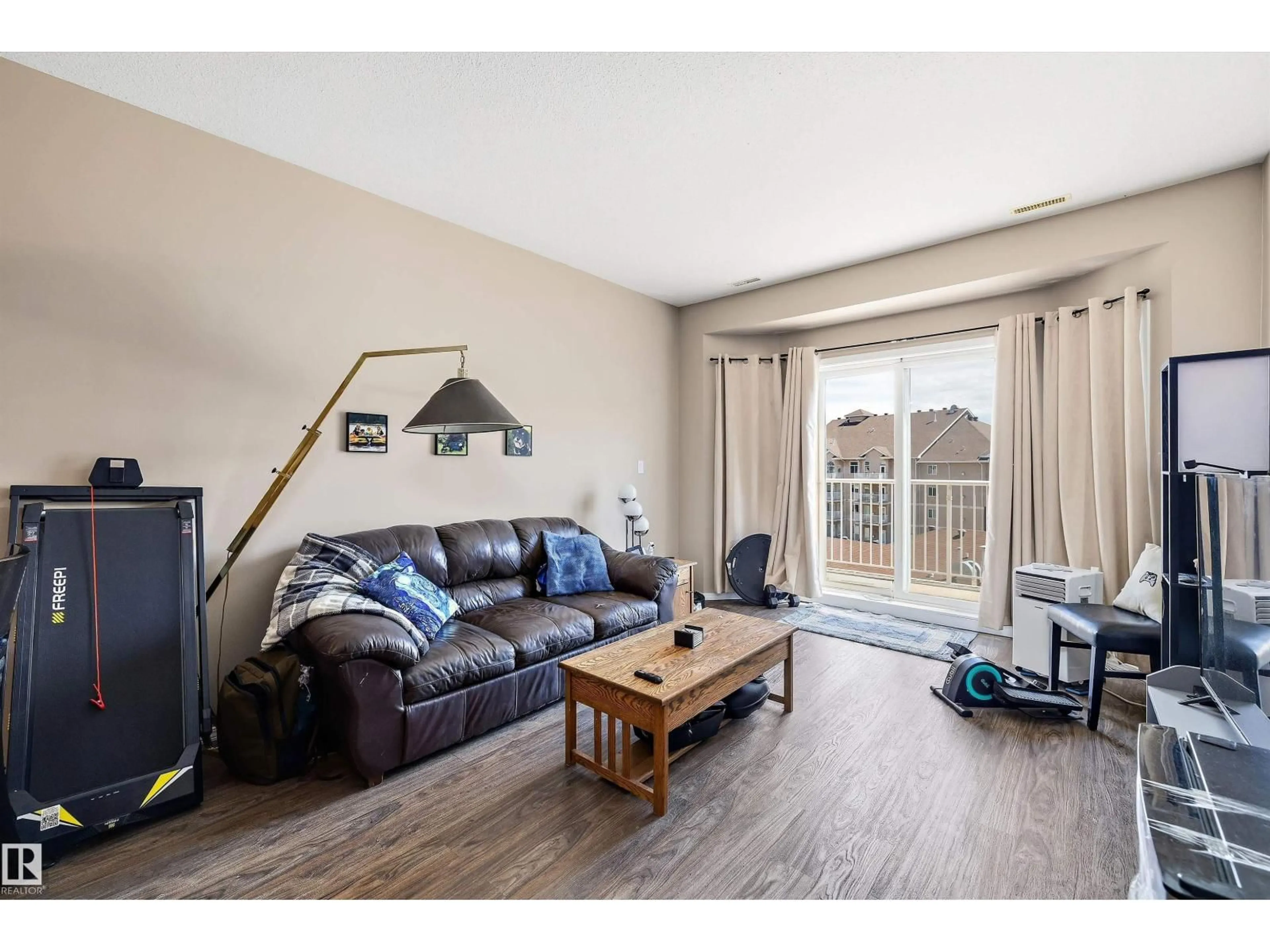 Living room with furniture, wood/laminate floor for #417 - 4316 139 AV, Edmonton Alberta T5Y0C1