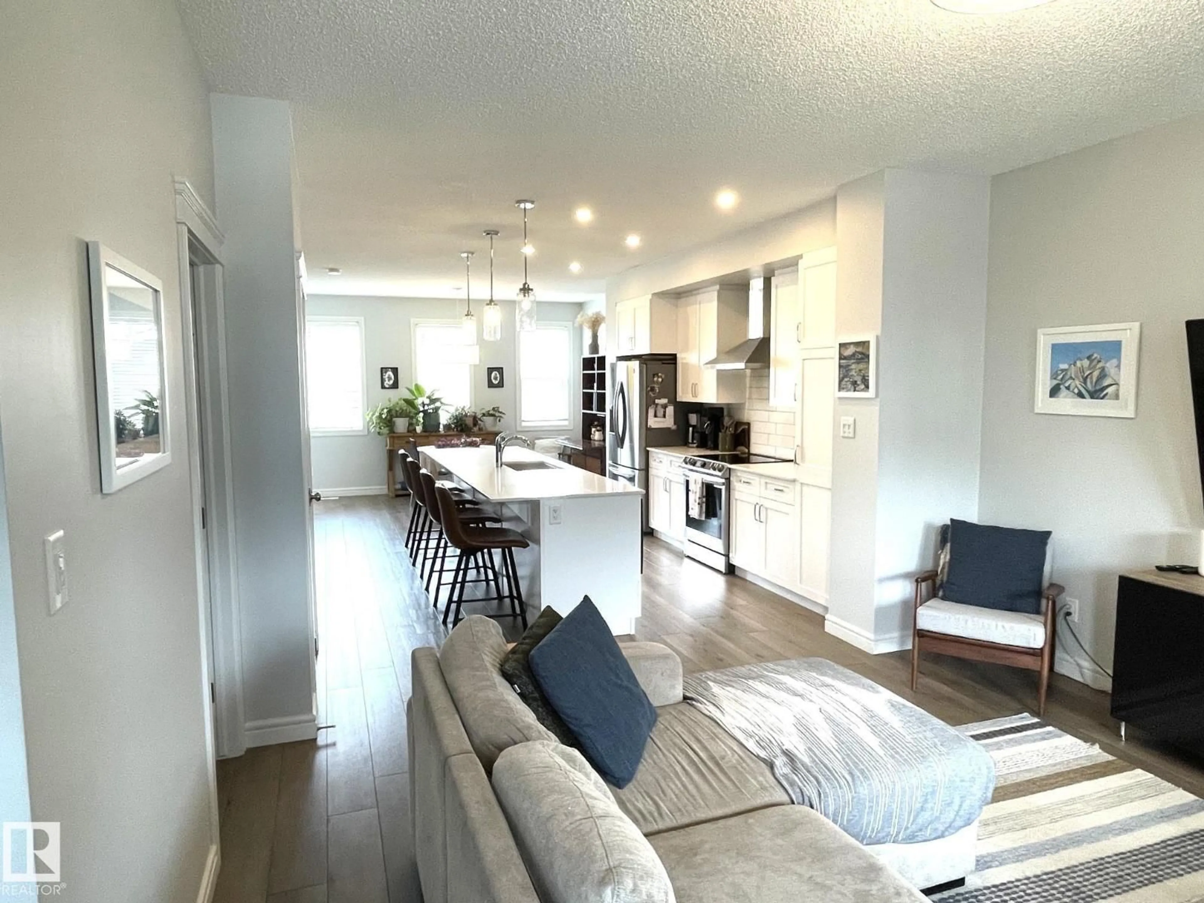 Open concept kitchen, wood/laminate floor for 19227 27 AV, Edmonton Alberta T6M1L1
