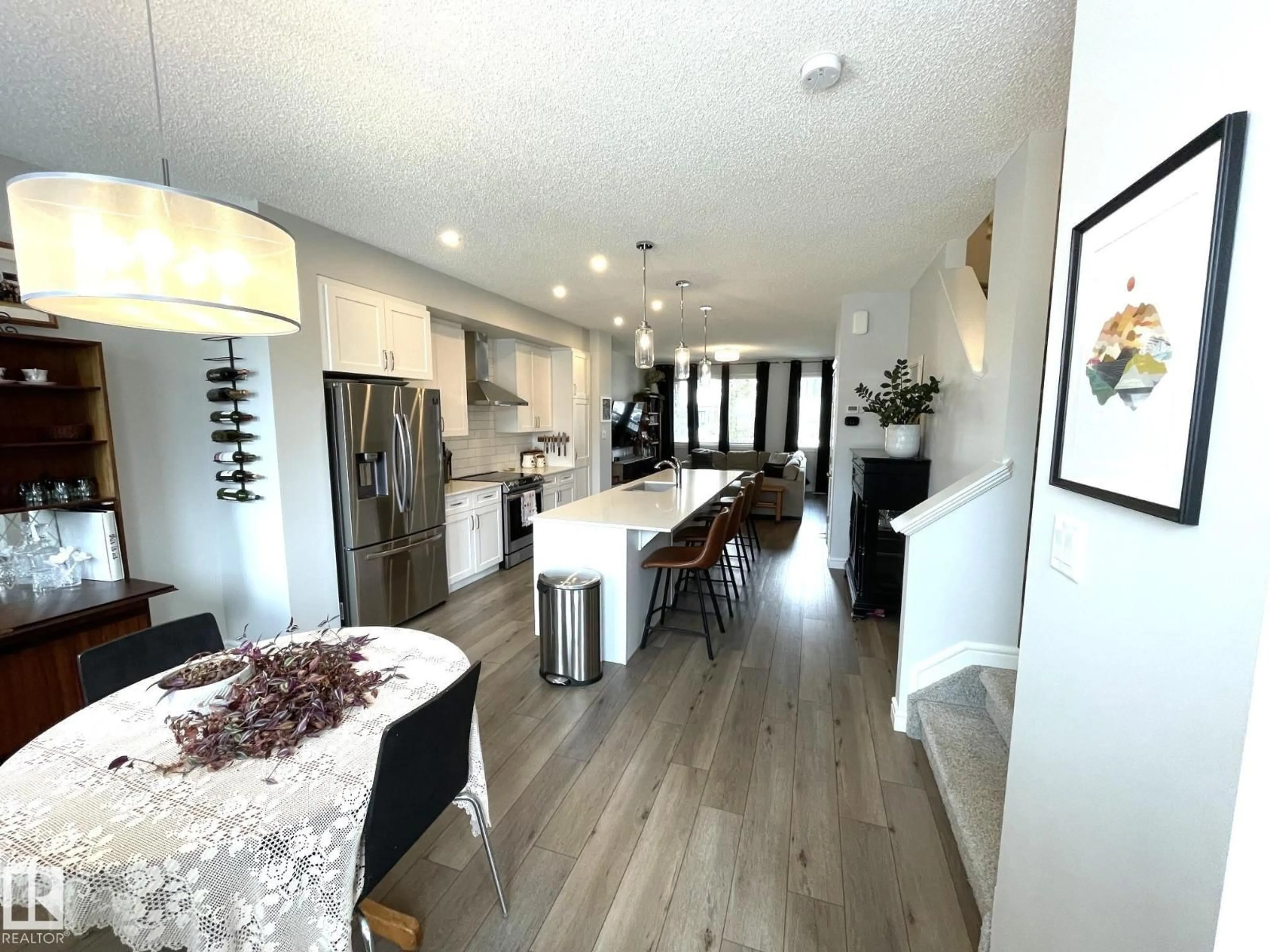 Open concept kitchen, wood/laminate floor for 19227 27 AV, Edmonton Alberta T6M1L1