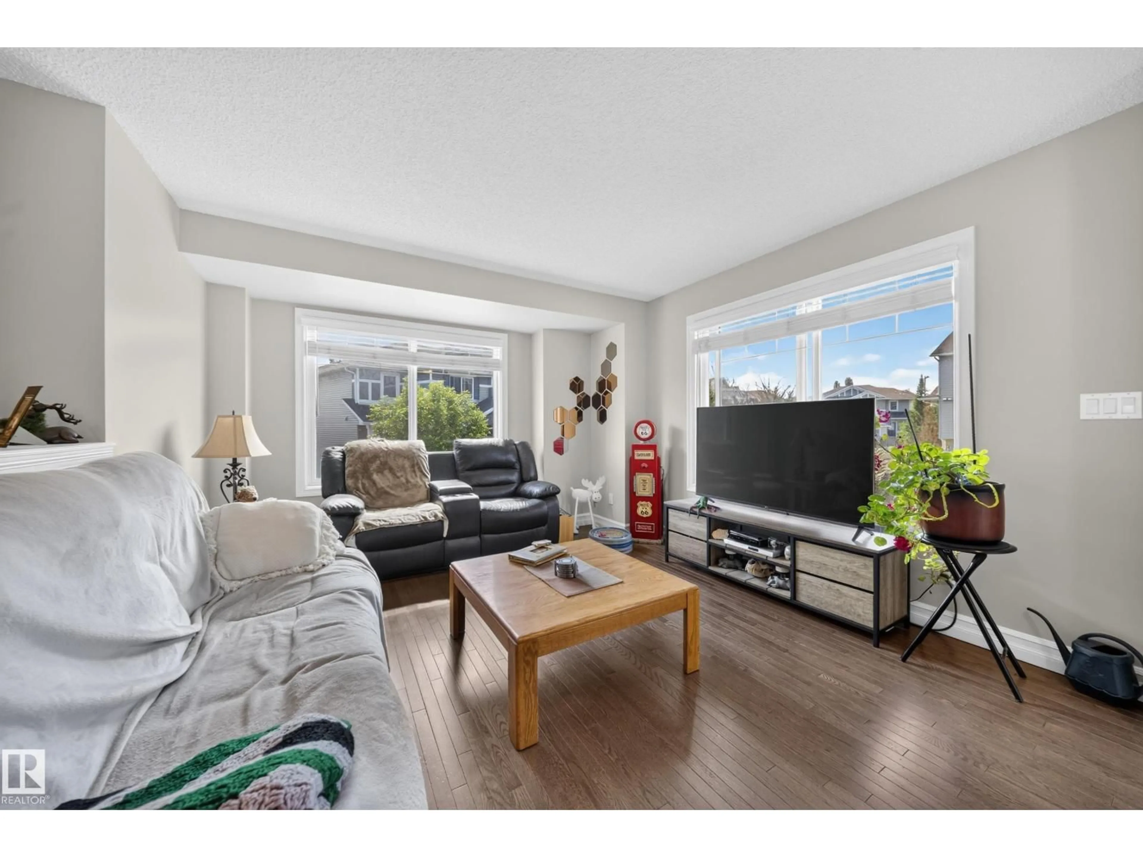 Living room with furniture, wood/laminate floor for 655 - 64 TAMARACK RD, Edmonton Alberta T6T0N4