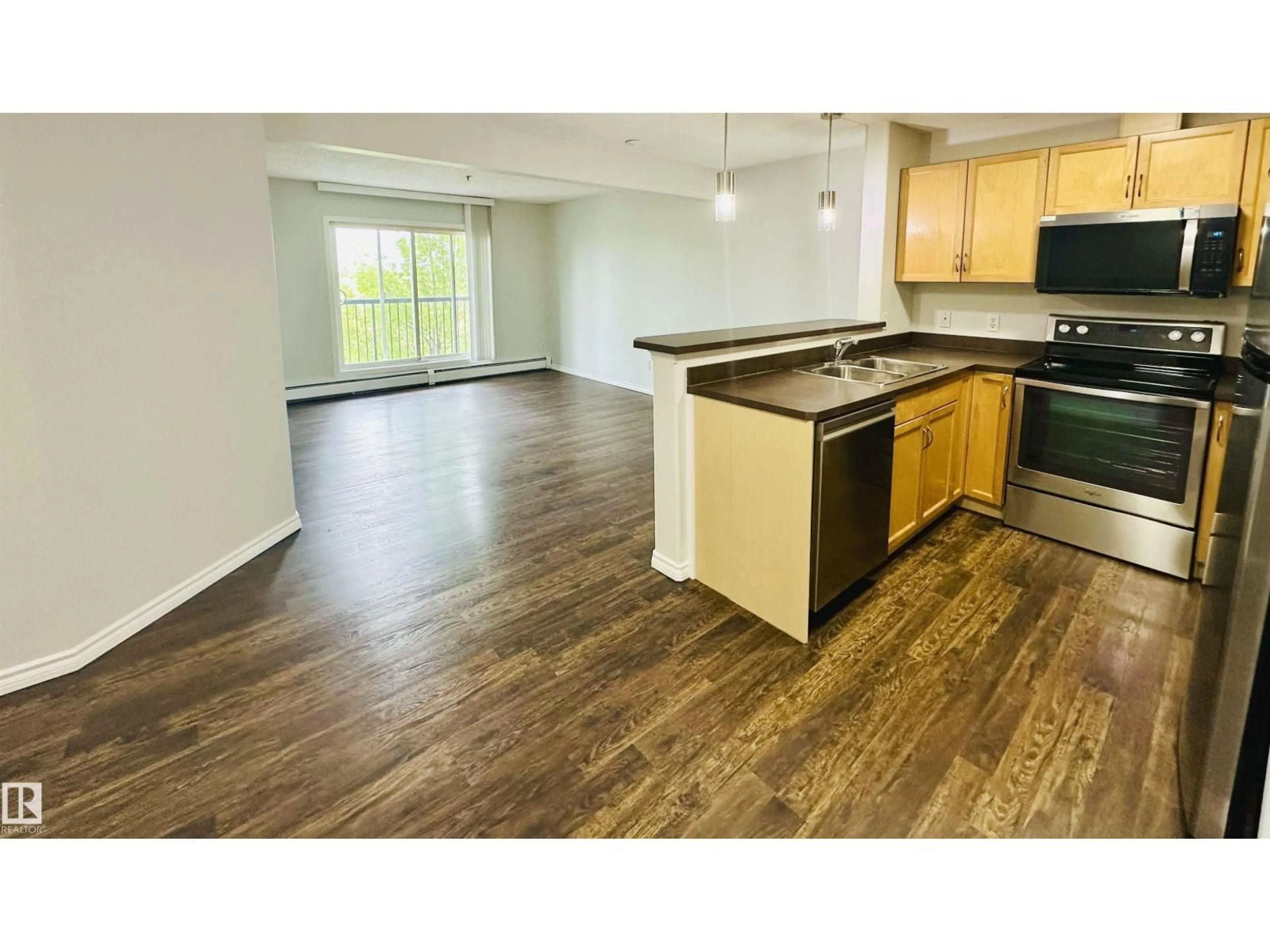 Open concept kitchen, wood/laminate floor for #318 - 646 MCALLISTER LO, Edmonton Alberta T6W0B5
