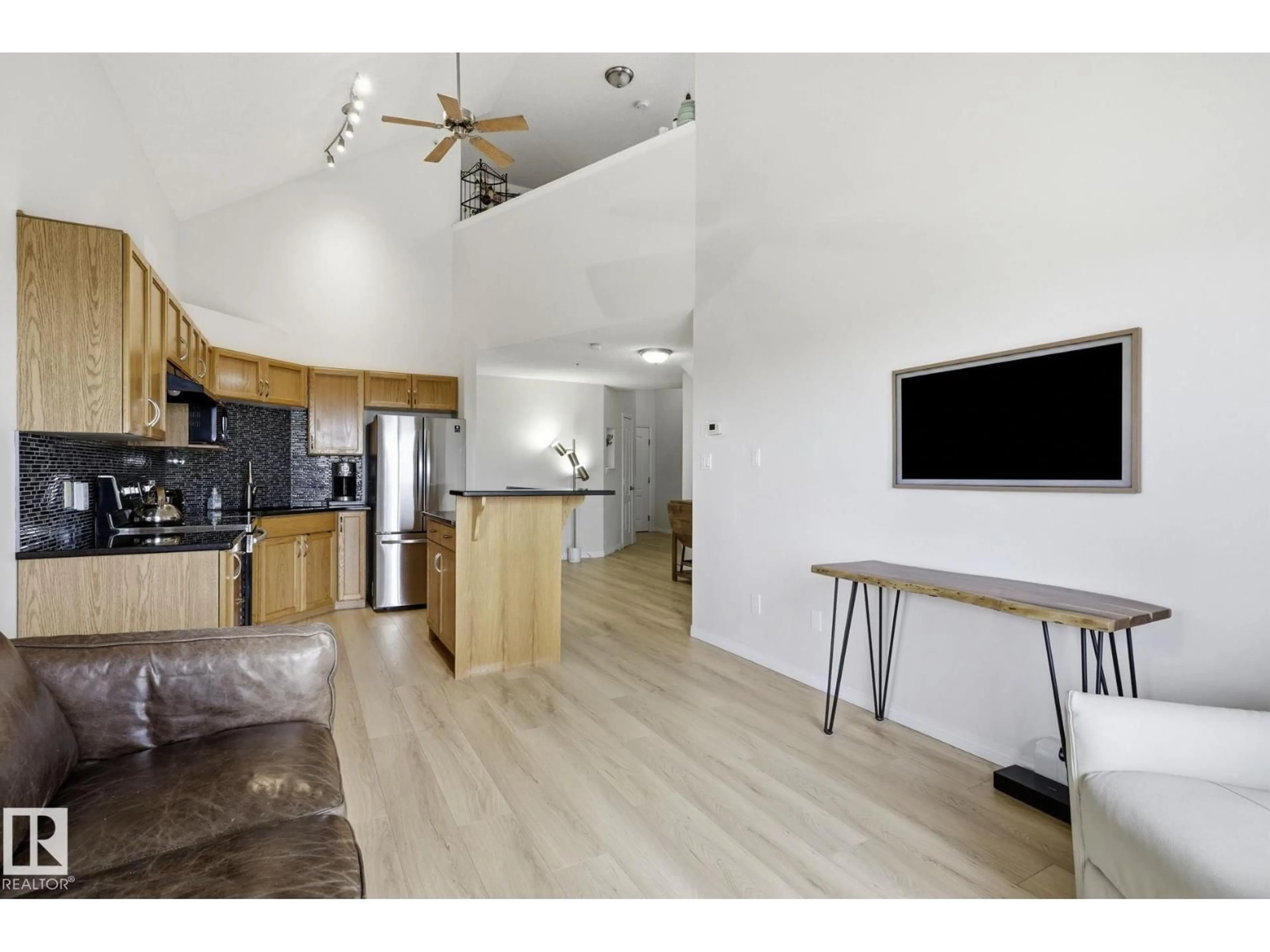 Open concept kitchen, wood/laminate floor for #426 - 3425 19 ST, Edmonton Alberta T6T2B5