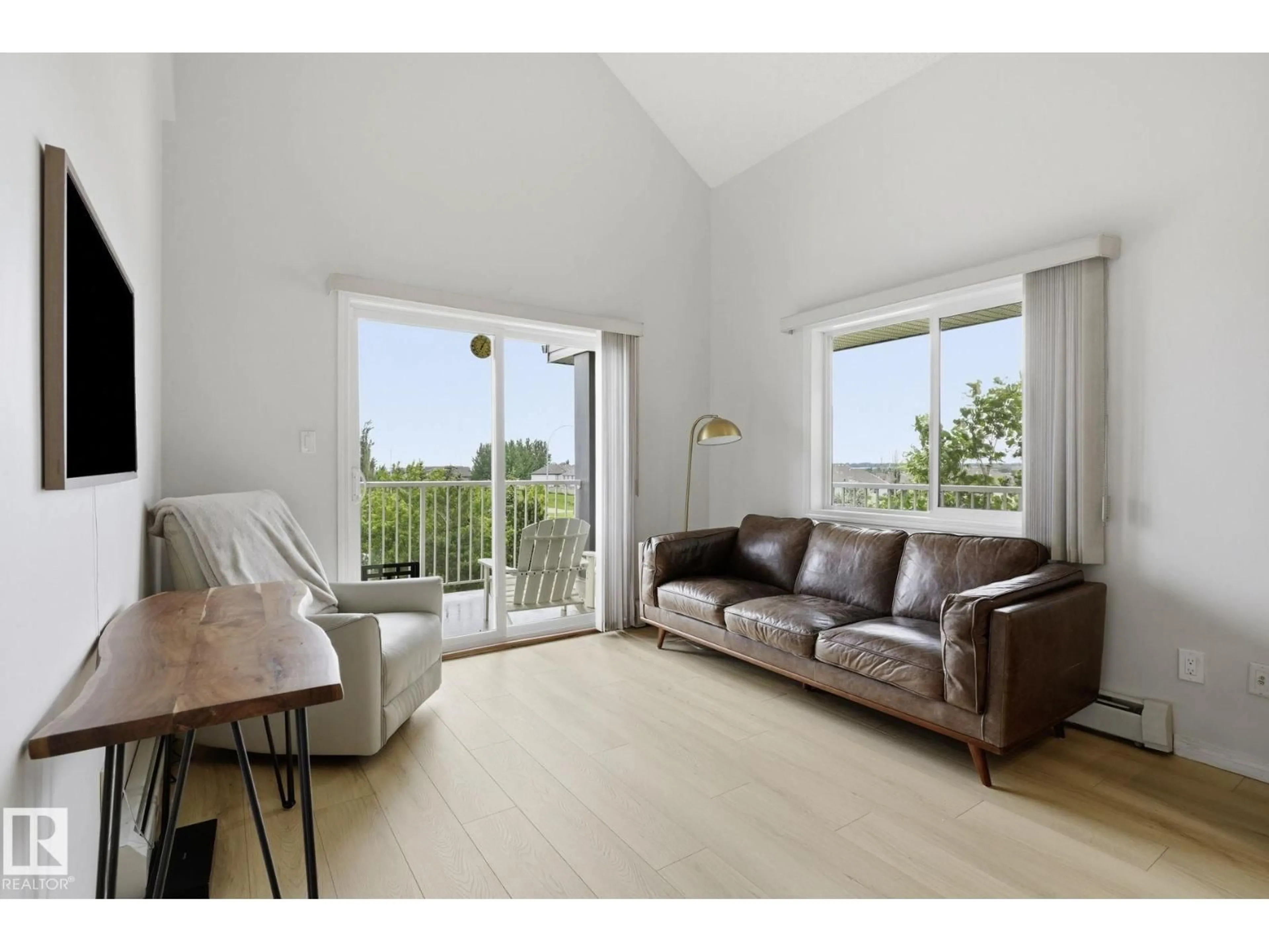 Living room with furniture, wood/laminate floor for #426 - 3425 19 ST, Edmonton Alberta T6T2B5