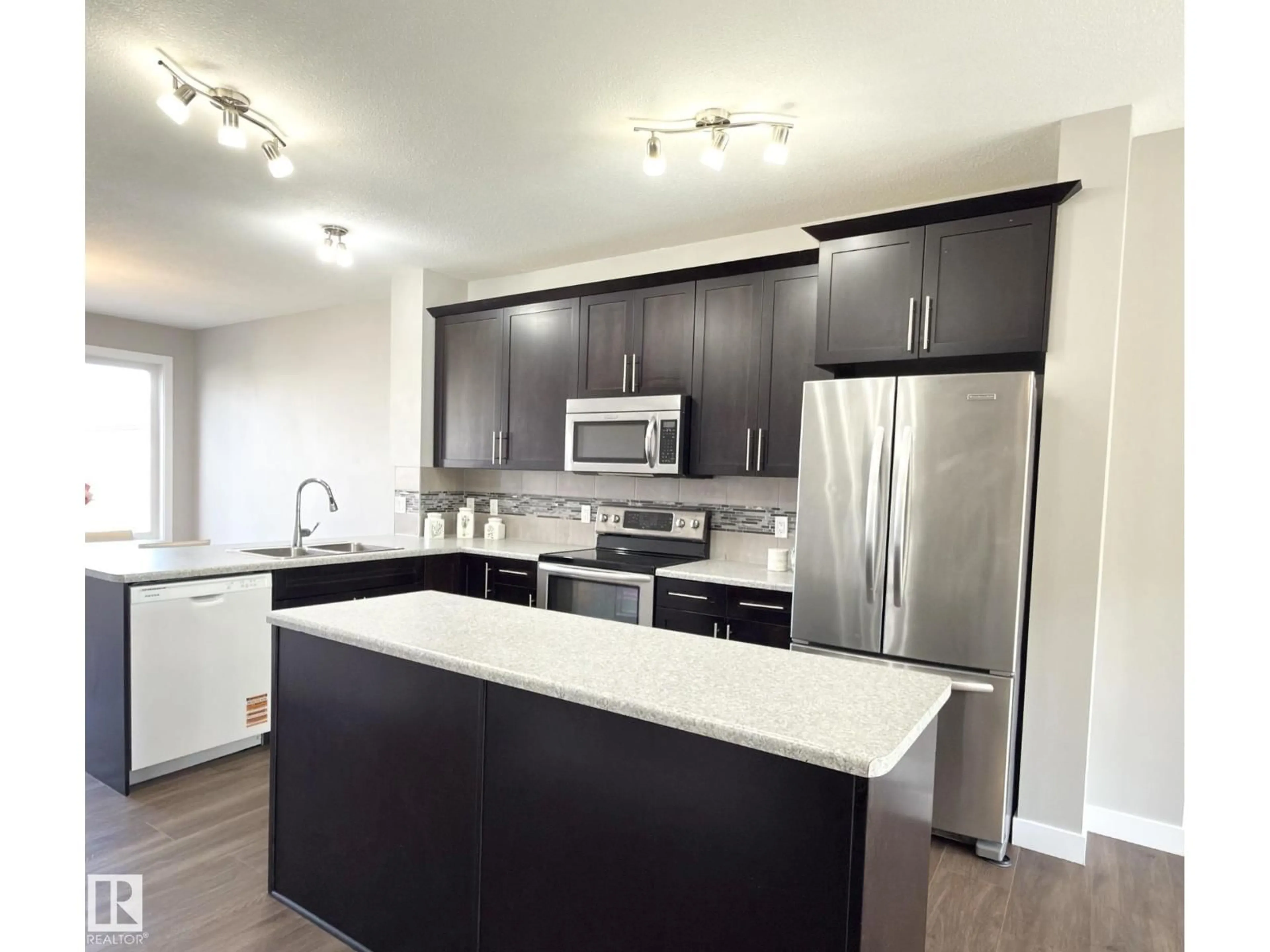 Open concept kitchen, wood/laminate floor for 3110 PAISLEY RD, Edmonton Alberta T6W1A3