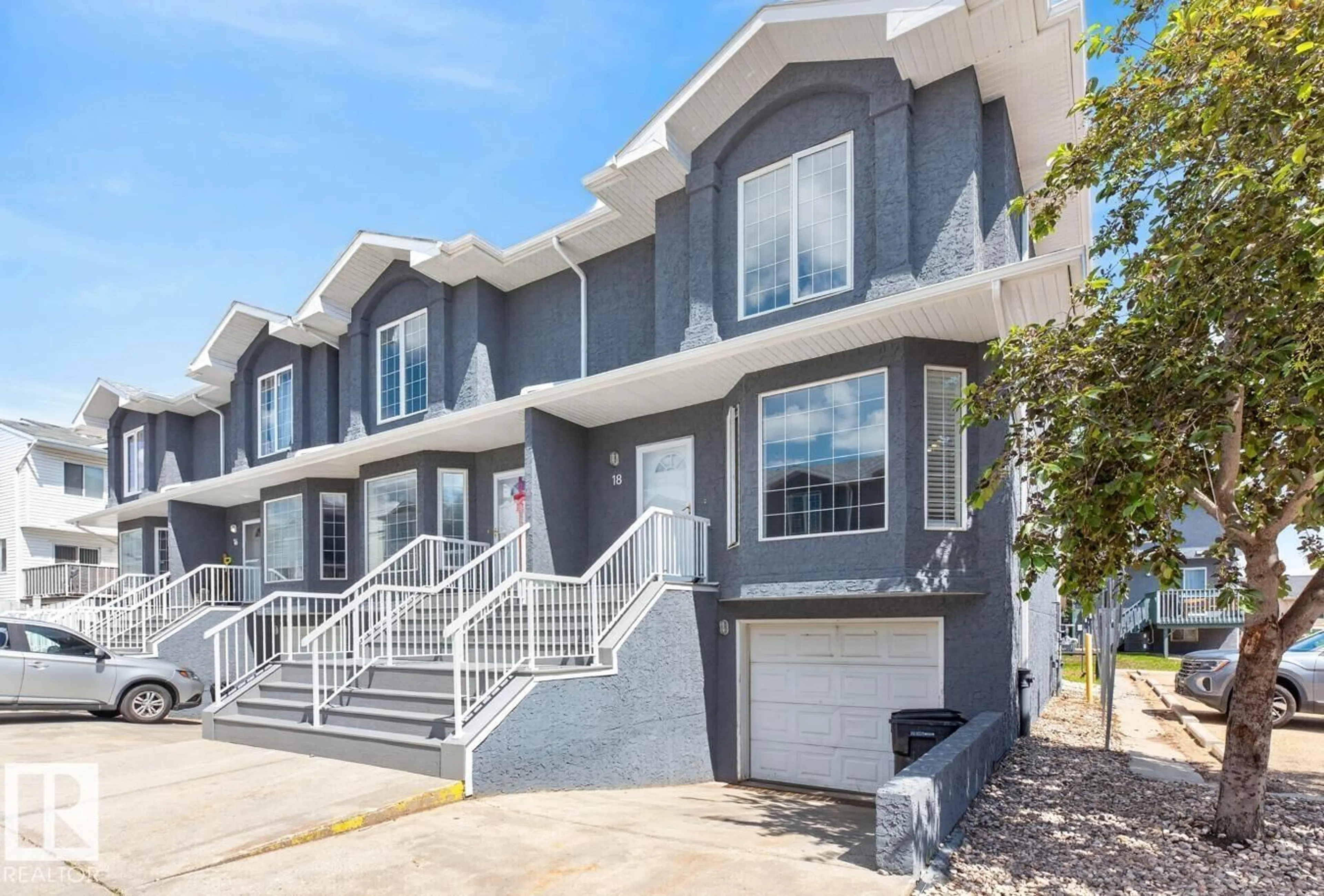 Home with vinyl exterior material, street for 18 15128 22 ST NW, Edmonton Alberta T5Y2W5