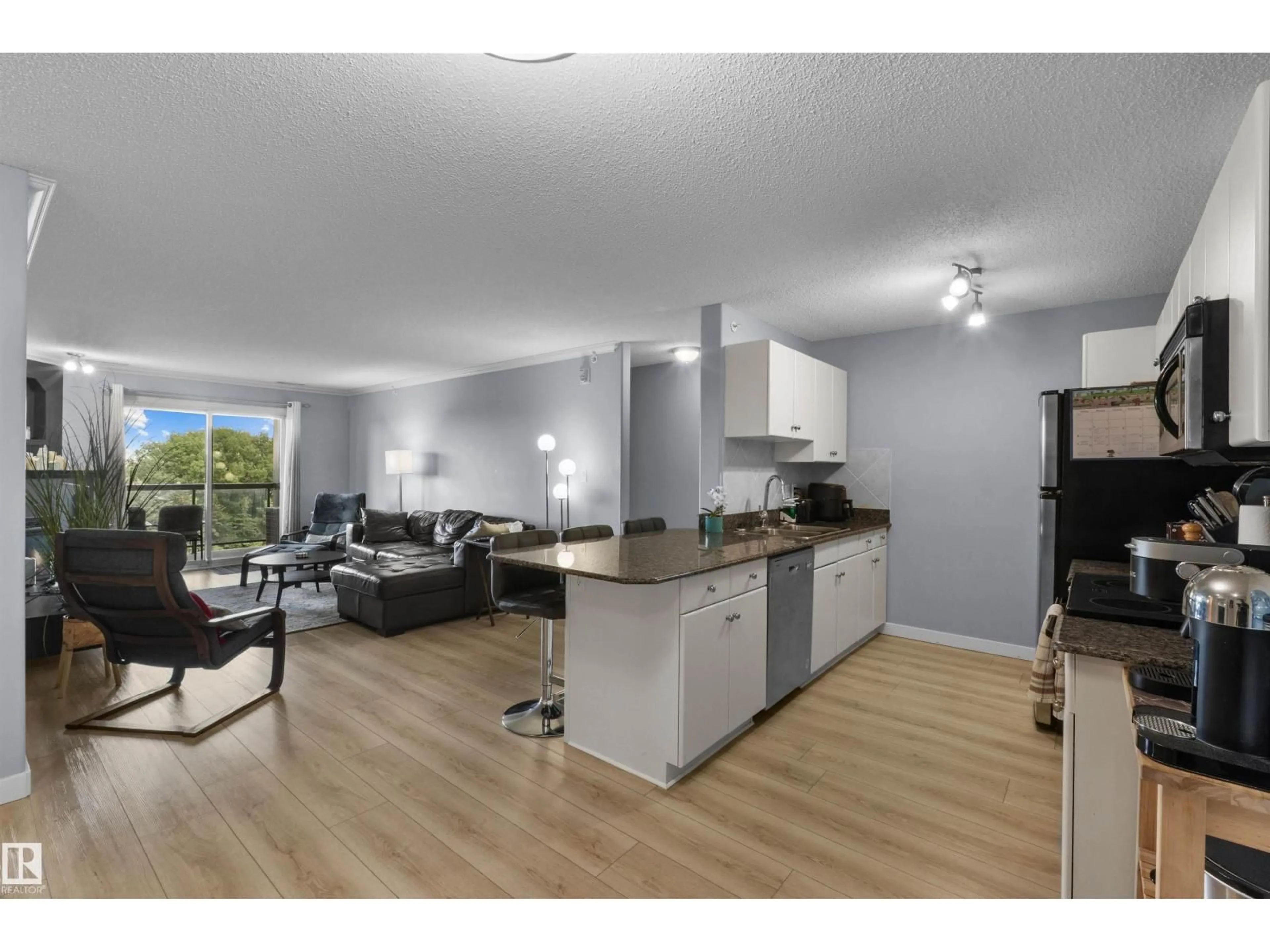 Open concept kitchen, wood/laminate floor for #414 - 279 SUDER GREENS DR, Edmonton Alberta T5T6X6