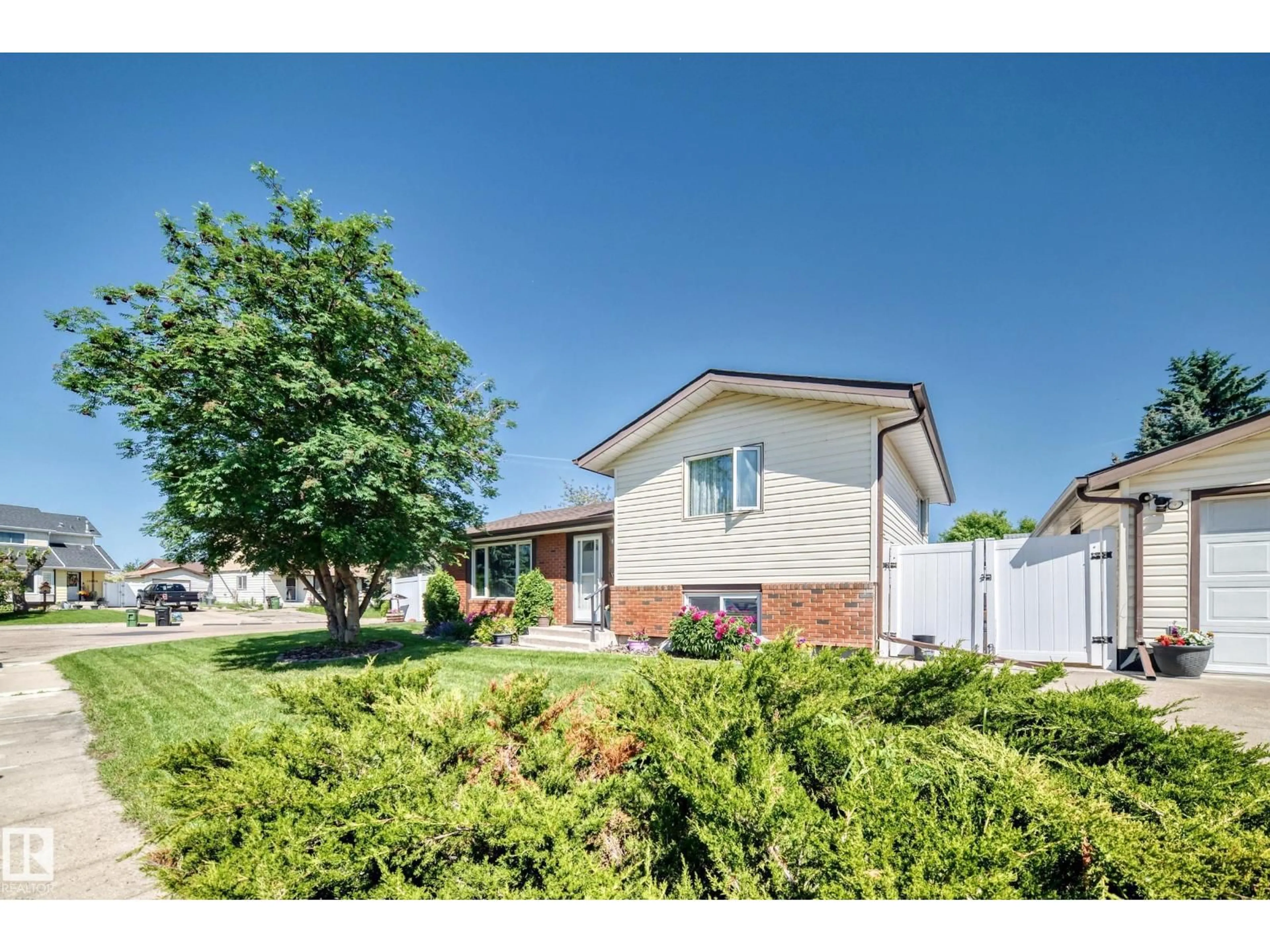 Home with vinyl exterior material, street for NW - 11708 138 AV, Edmonton Alberta T5X3P4
