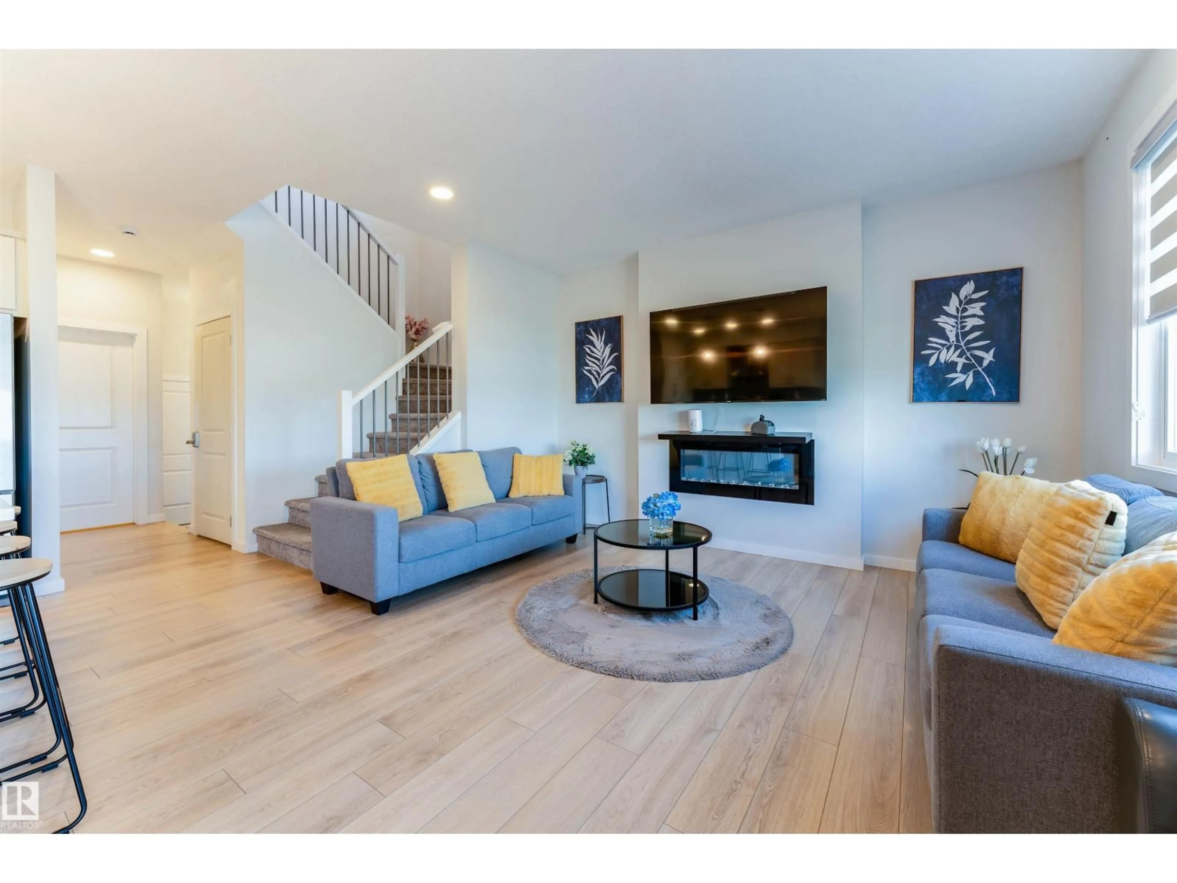 Living room with furniture, wood/laminate floor for 8426 228A ST, Edmonton Alberta T5T4A3