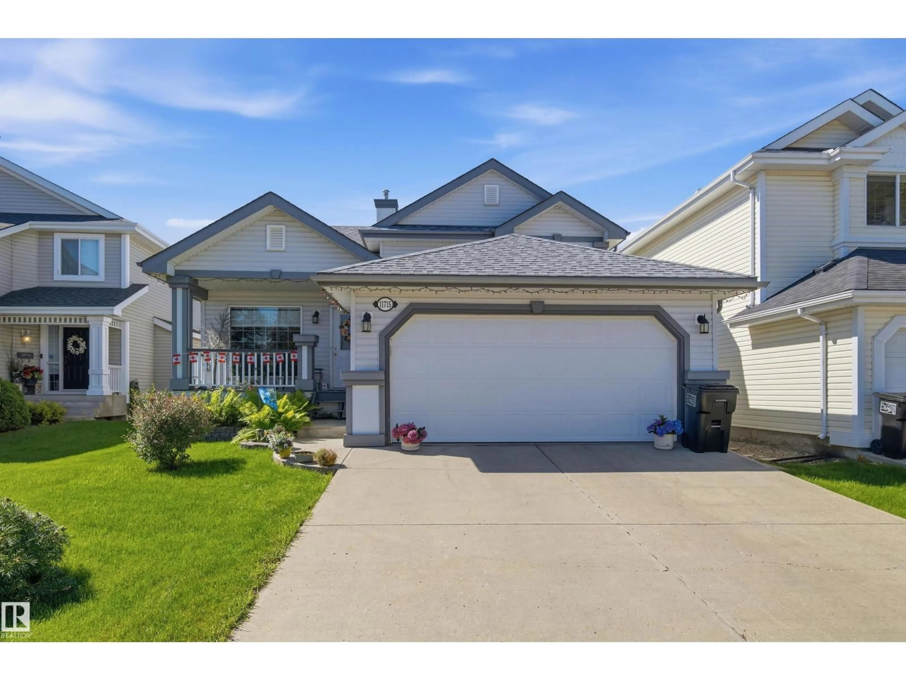 Home with vinyl exterior material, street for NW - 11715 11B AV, Edmonton Alberta T6J7E5
