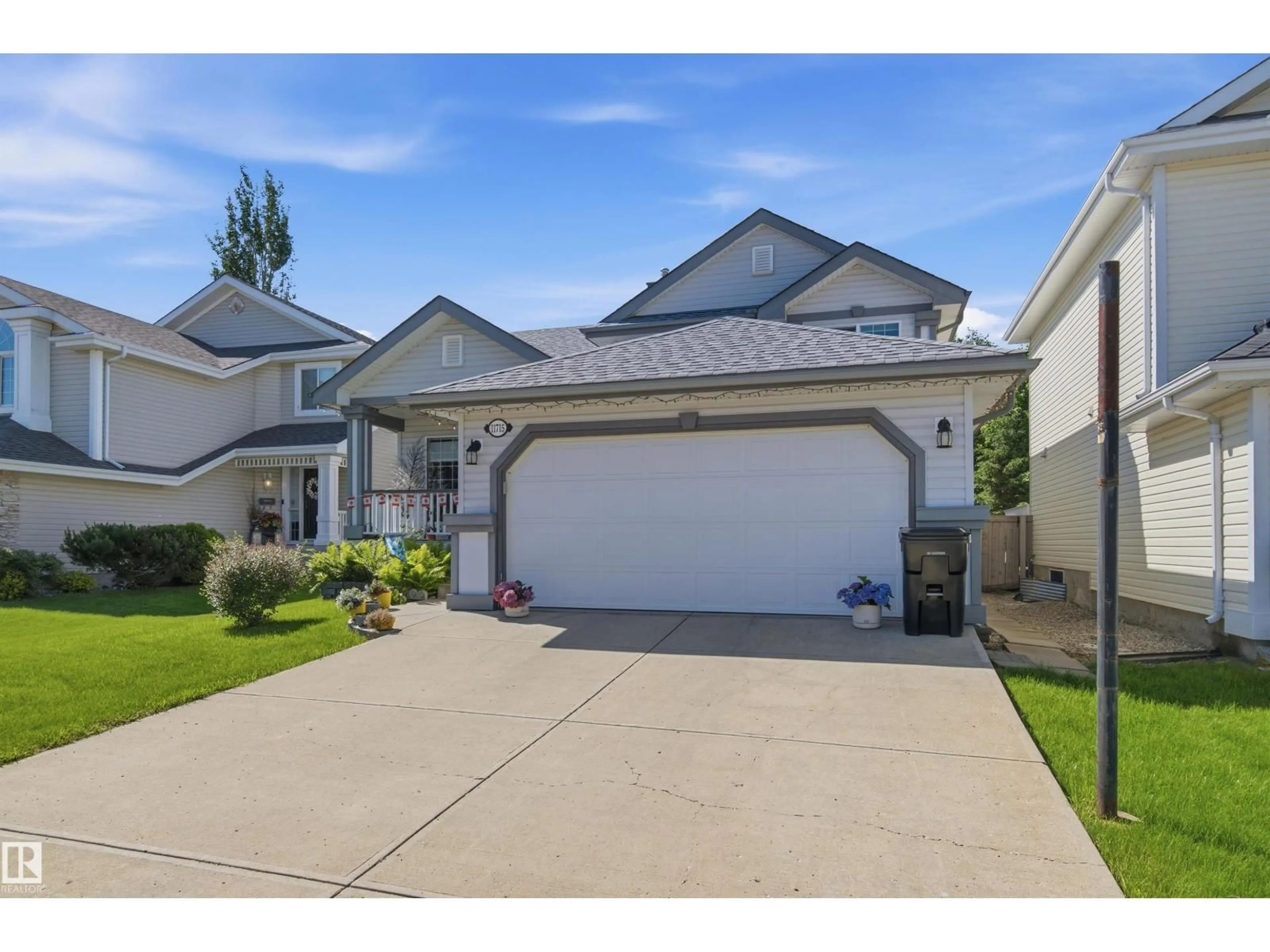 Home with vinyl exterior material, street for NW - 11715 11B AV, Edmonton Alberta T6J7E5