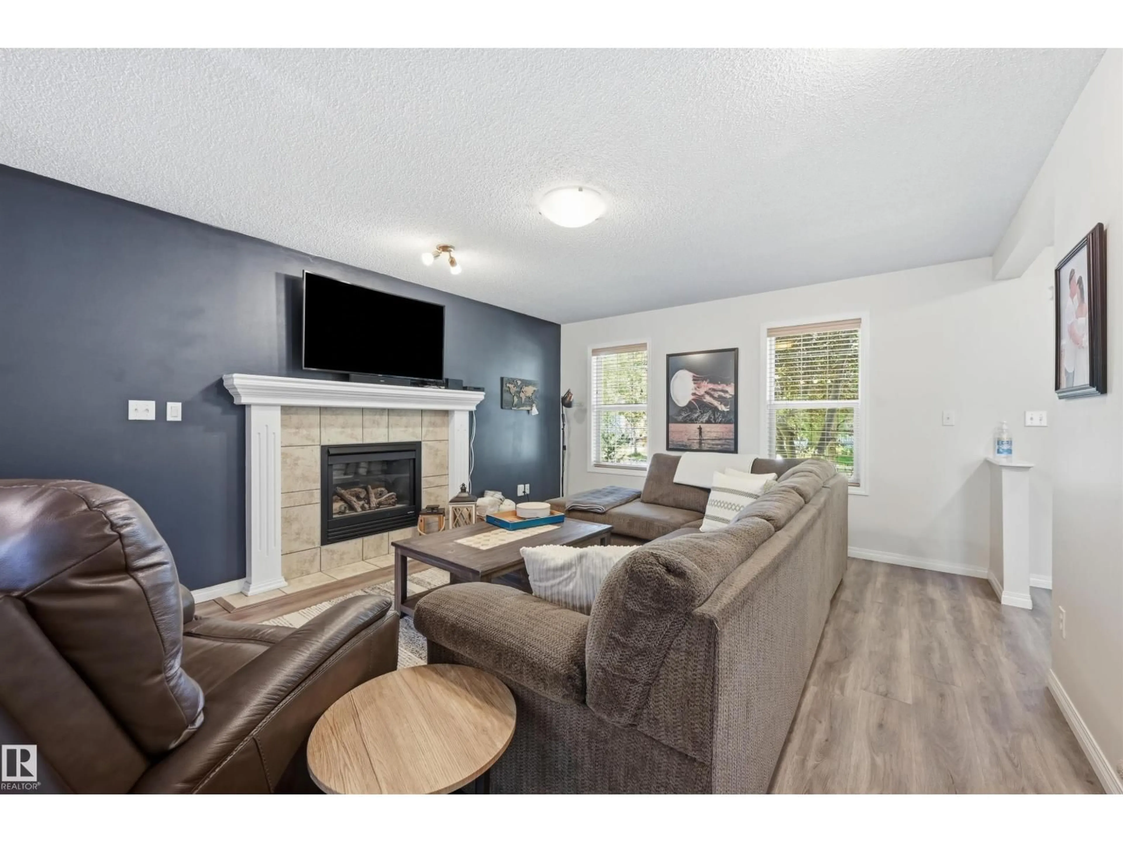 Living room with furniture, wood/laminate floor for SW - 12028 18 AV, Edmonton Alberta T6W1W2