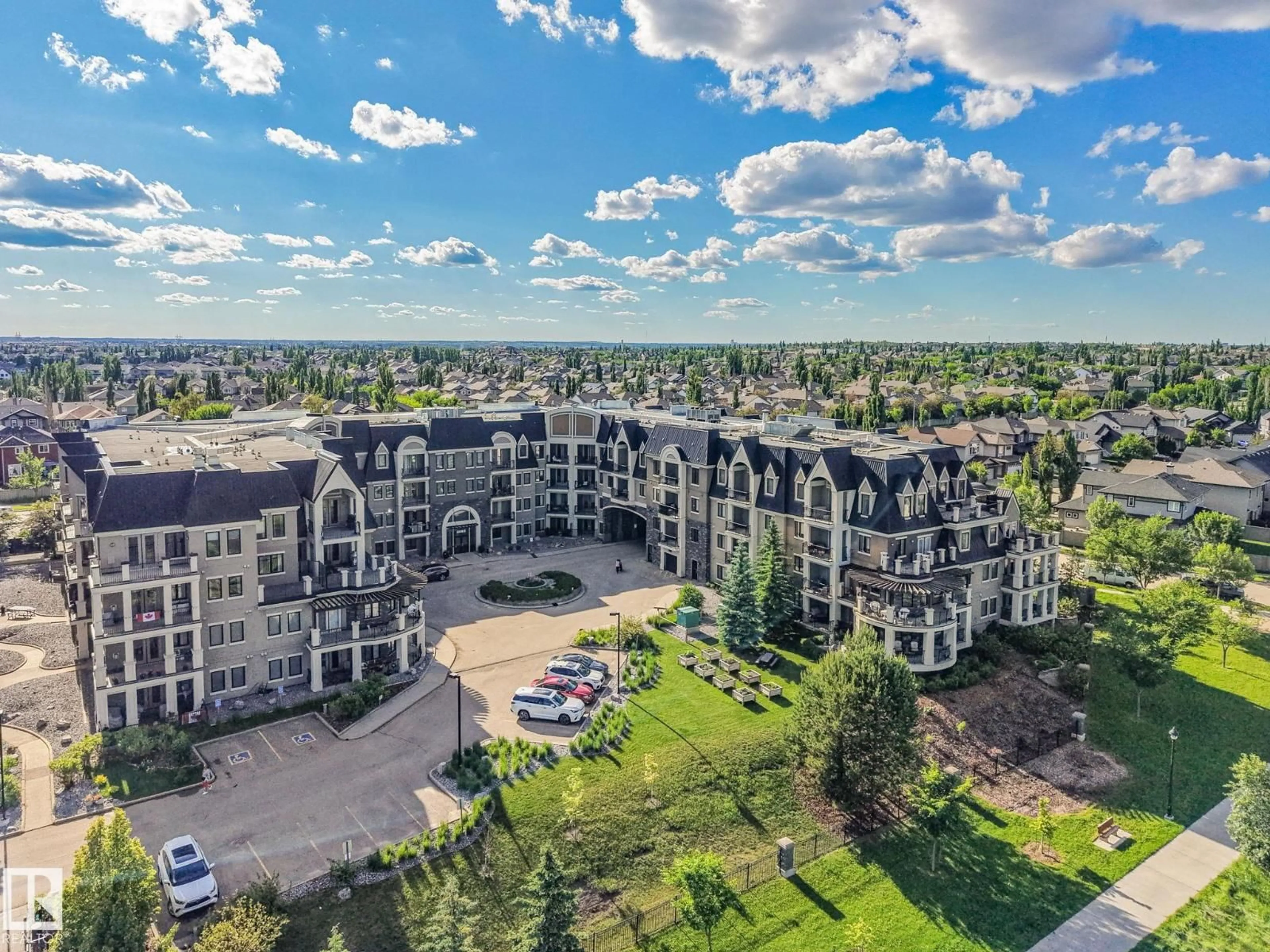 A pic from outside/outdoor area/front of a property/back of a property/a pic from drone, mountain view for #403 - 6083 MAYNARD WY, Edmonton Alberta T6R0S5