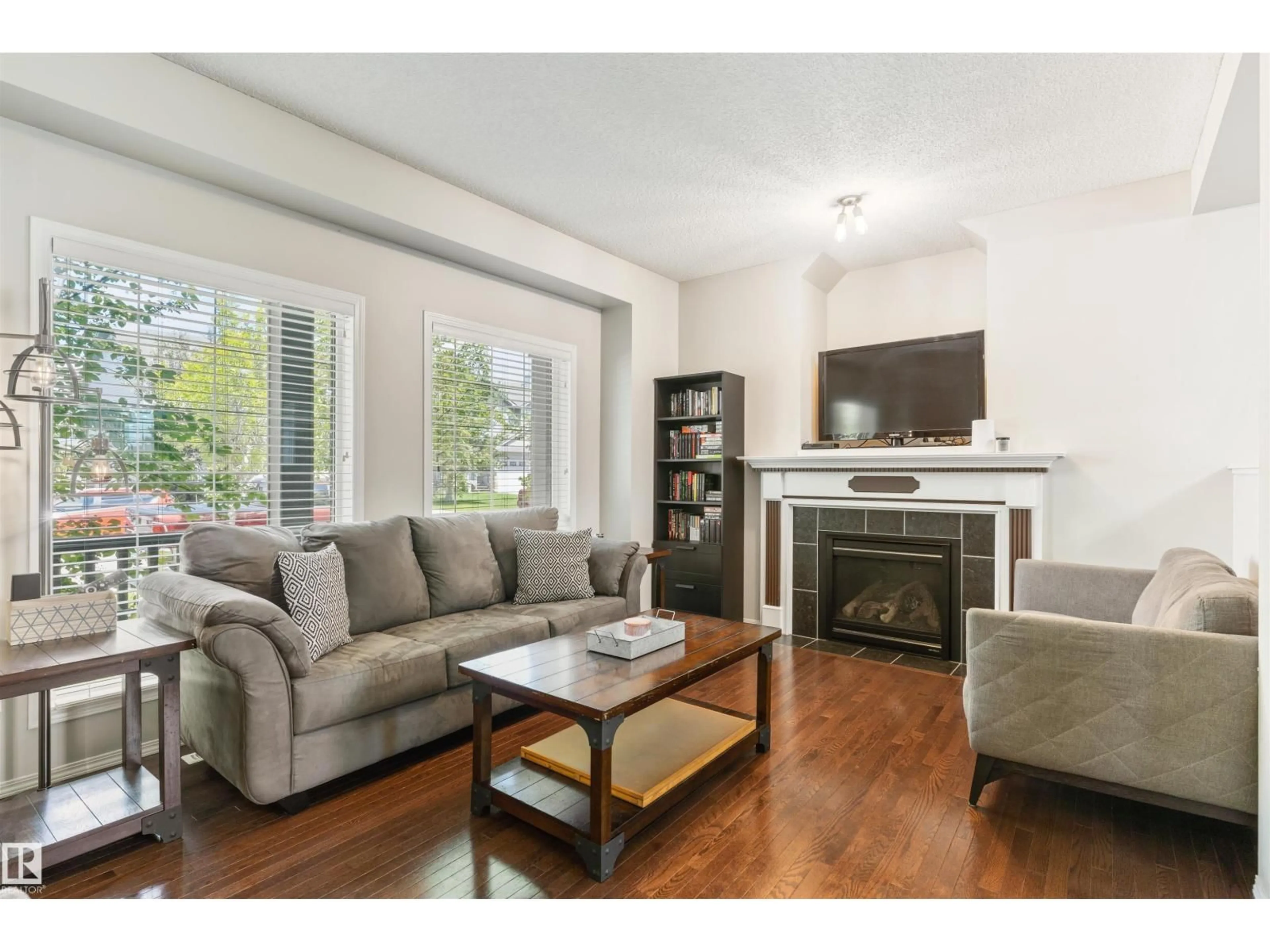 Living room with furniture, wood/laminate floor for 8774 STEIN LN, Edmonton Alberta T6R0L5