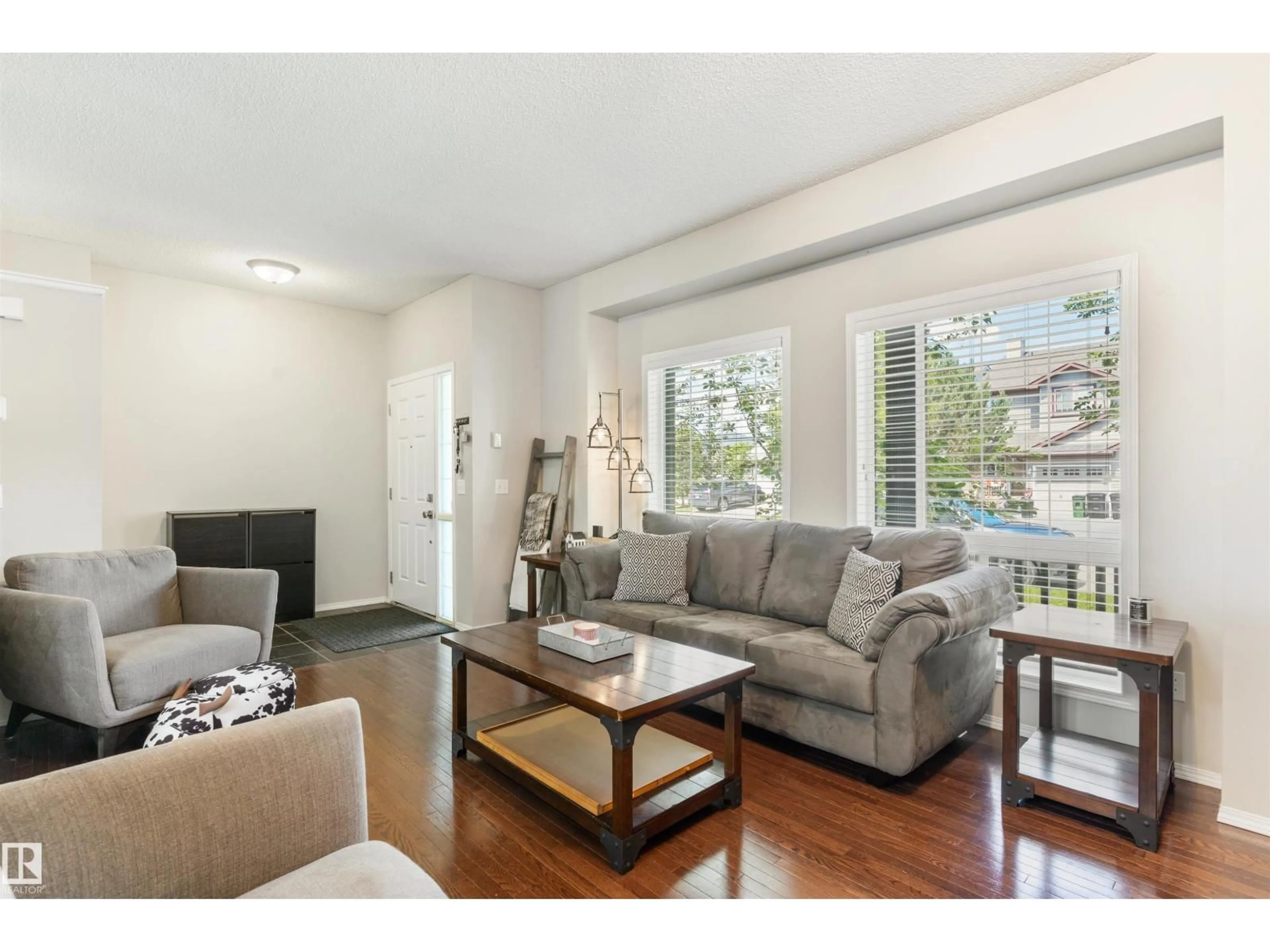 Living room with furniture, wood/laminate floor for 8774 STEIN LN, Edmonton Alberta T6R0L5