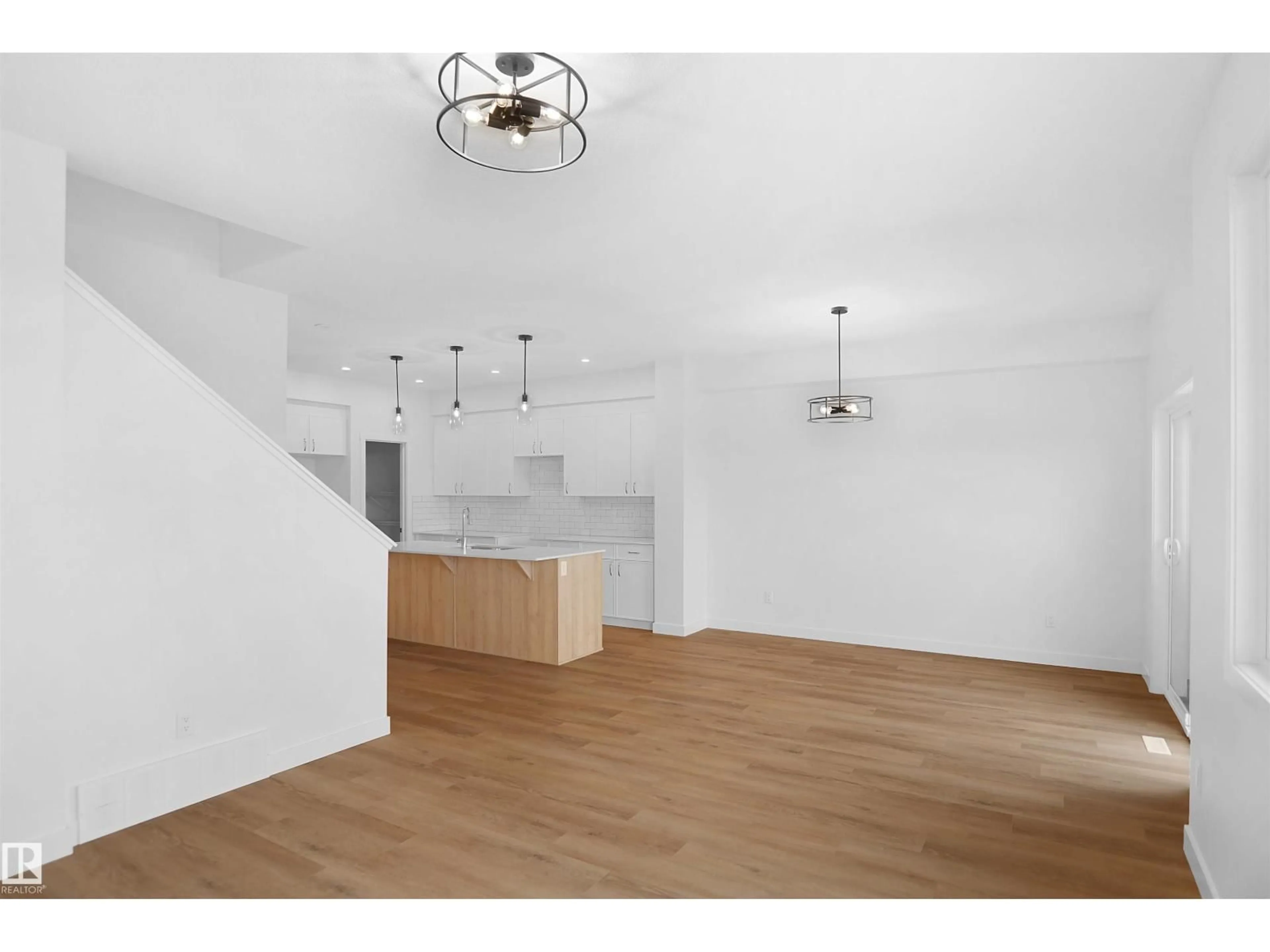 Open concept kitchen, wood/laminate floor for 956 17 AV, Edmonton Alberta T6T2S5