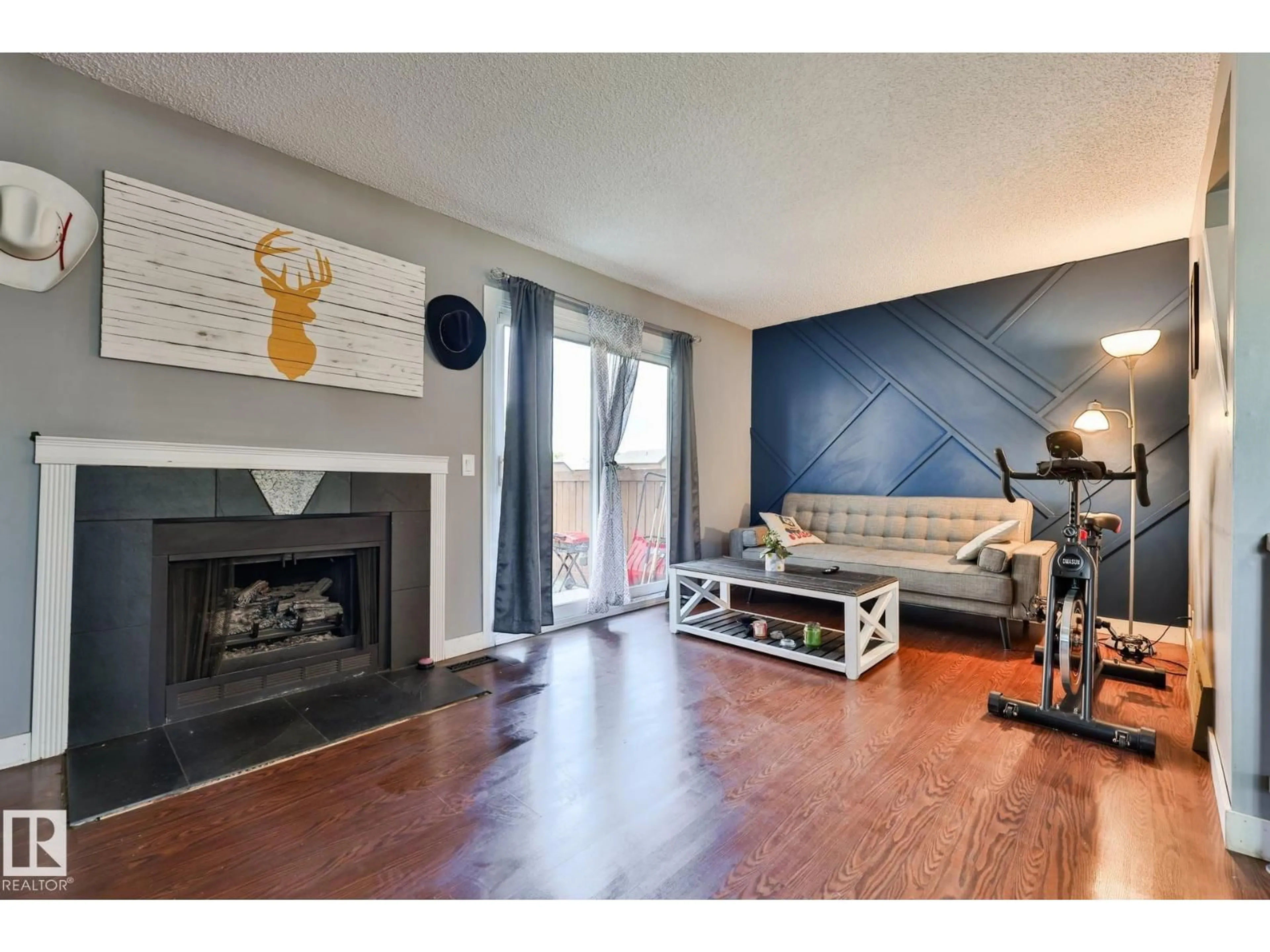 Living room with furniture, wood/laminate floor for 14567 52 ST, Edmonton Alberta T5A4N1
