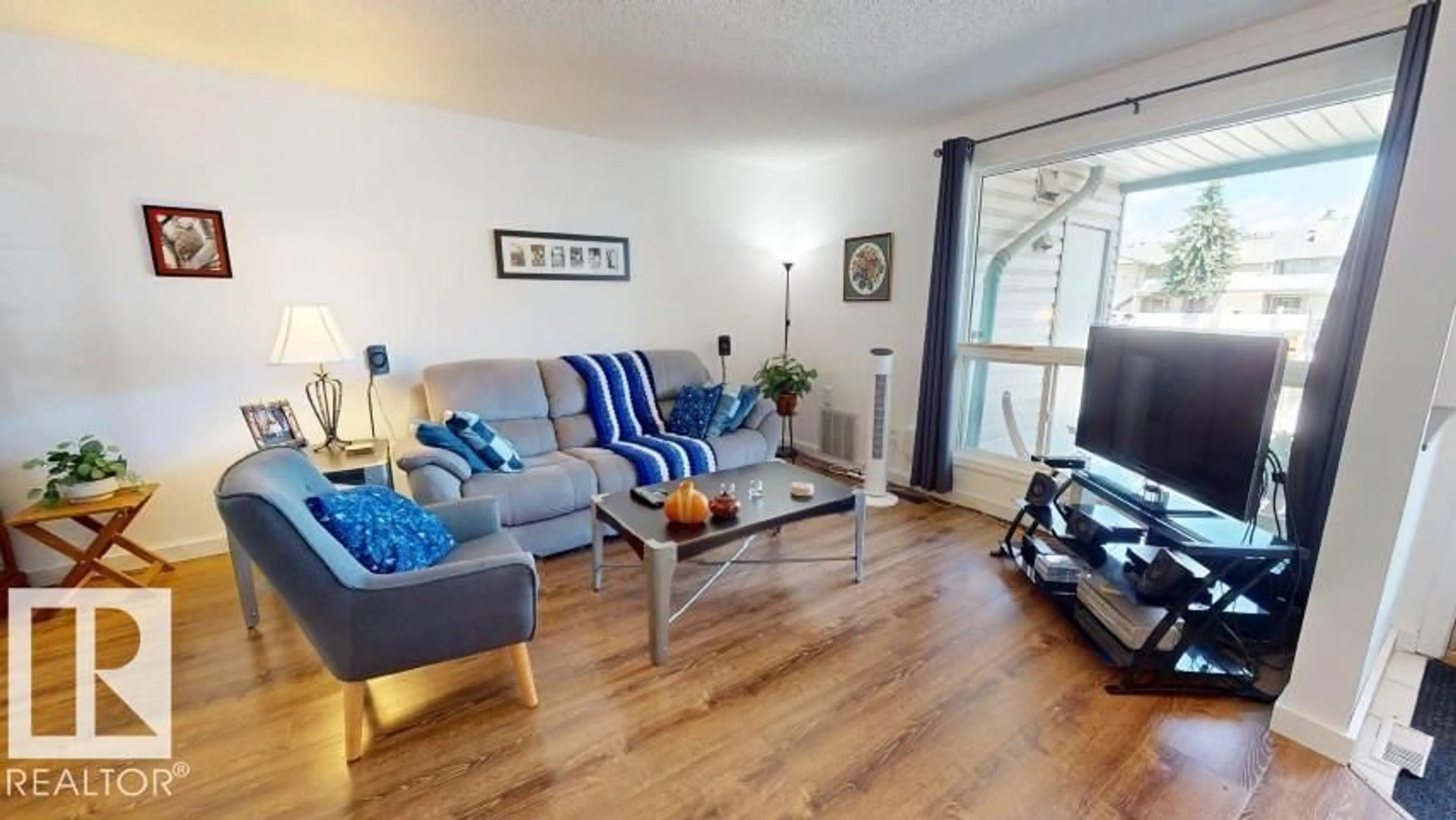 Living room with furniture, wood/laminate floor for Unit 73 - 2703 79 ST, Edmonton Alberta T6K3Z6