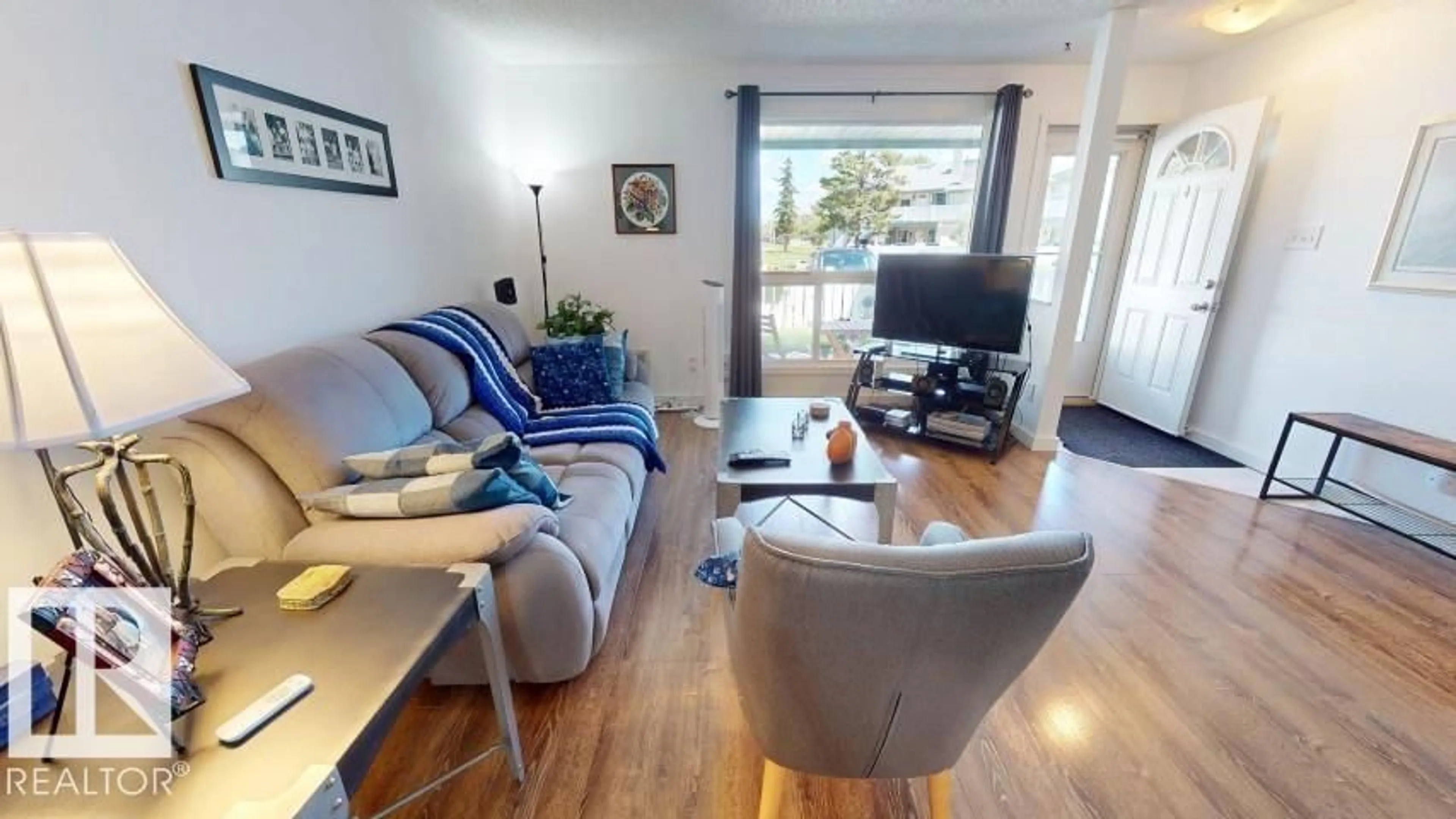 Living room with furniture, wood/laminate floor for Unit 73 - 2703 79 ST, Edmonton Alberta T6K3Z6