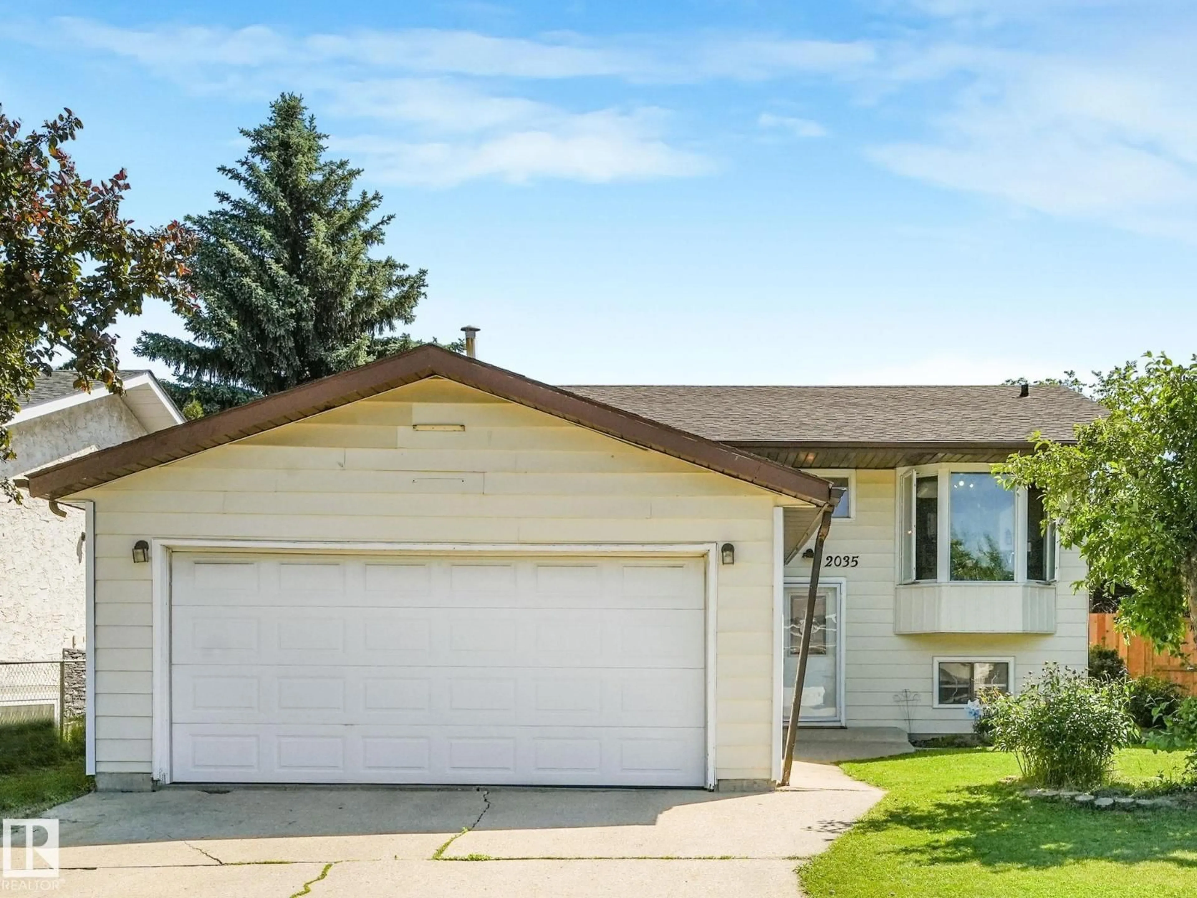 Home with vinyl exterior material, street for 2035 49A ST NW, Edmonton Alberta T6L2W9